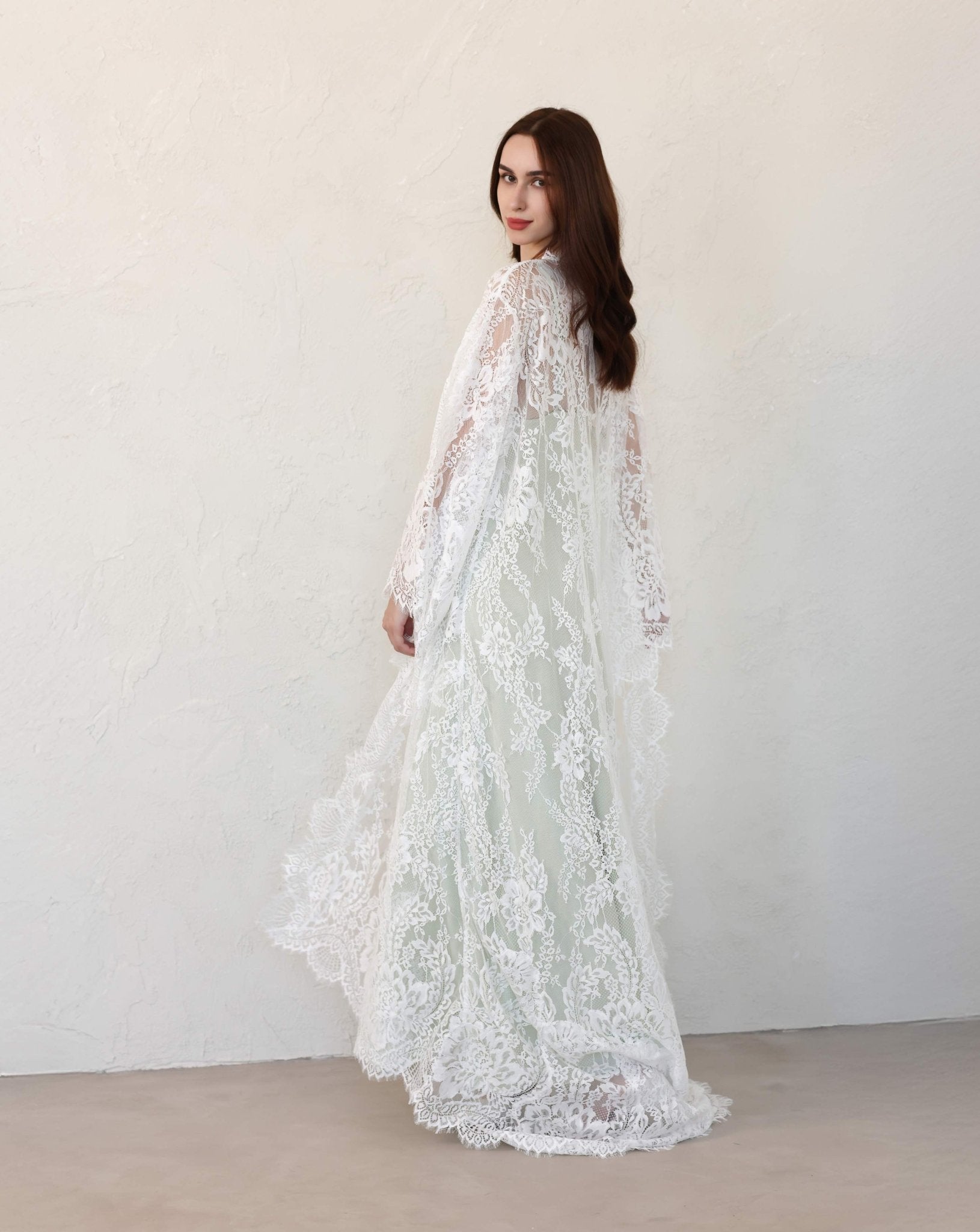 Kafemme bridal robe in green fabric
with lace details, styled in a golden setting