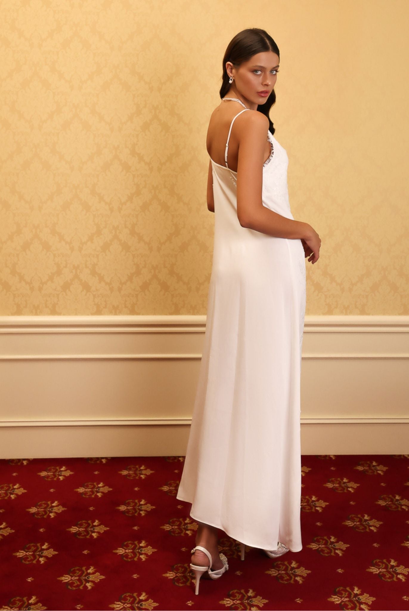 Kafemme bridal robe in ivory satin with lace details, styled in a golden setting