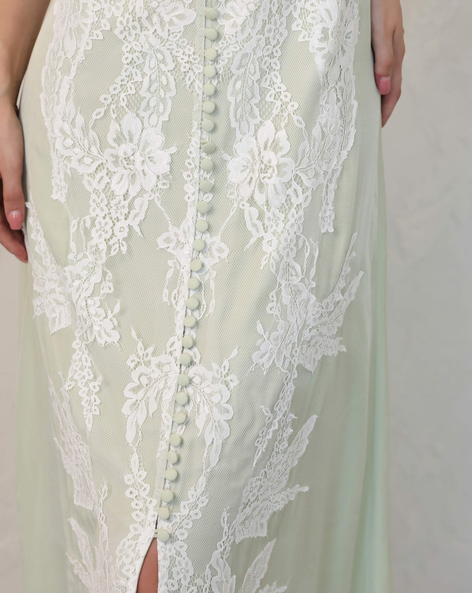 Close-up of lace embroidery and pearl buttons on Kafemme white robe set