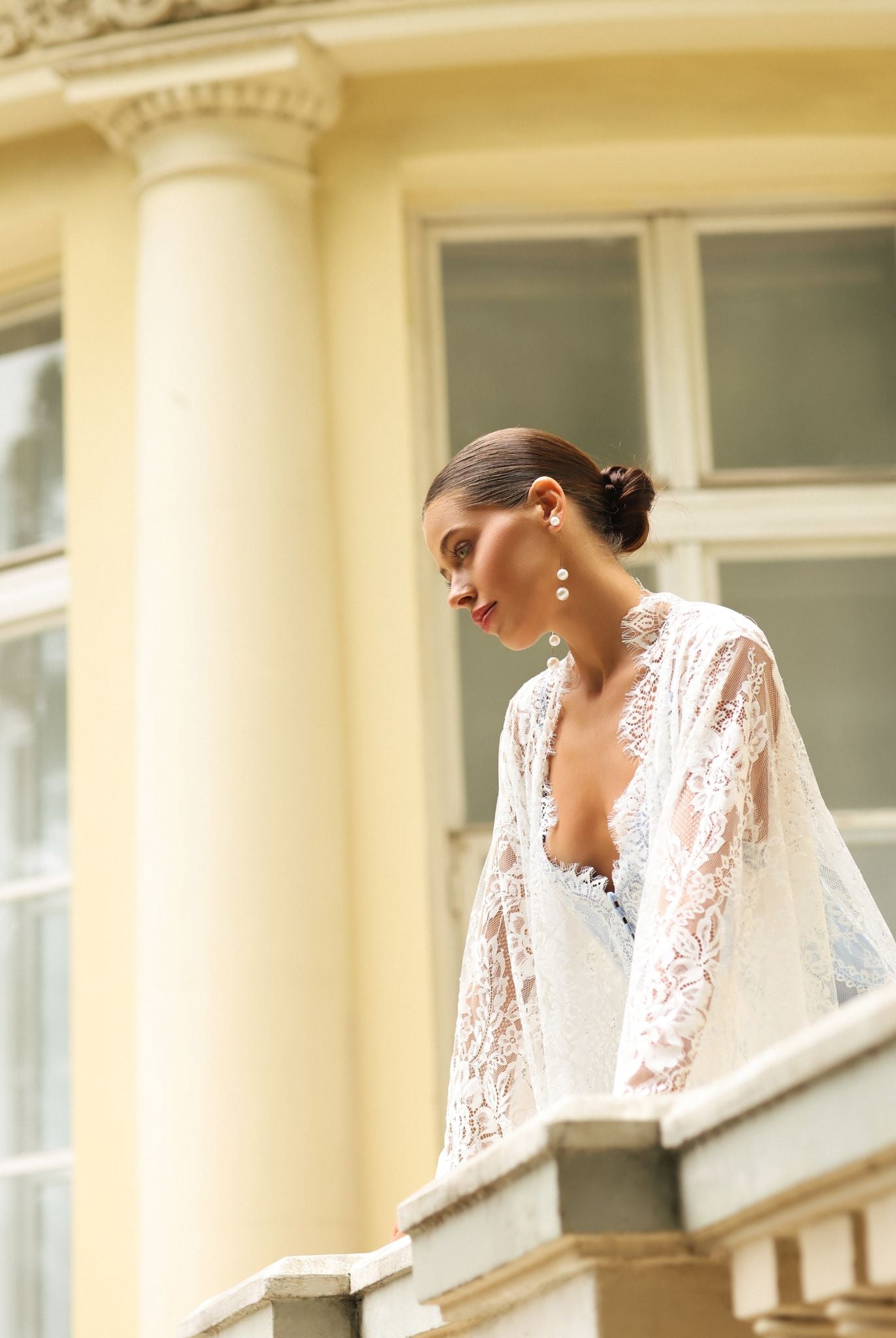 Kafemme lace maternity robe with open front, photographed on a balcony with columns