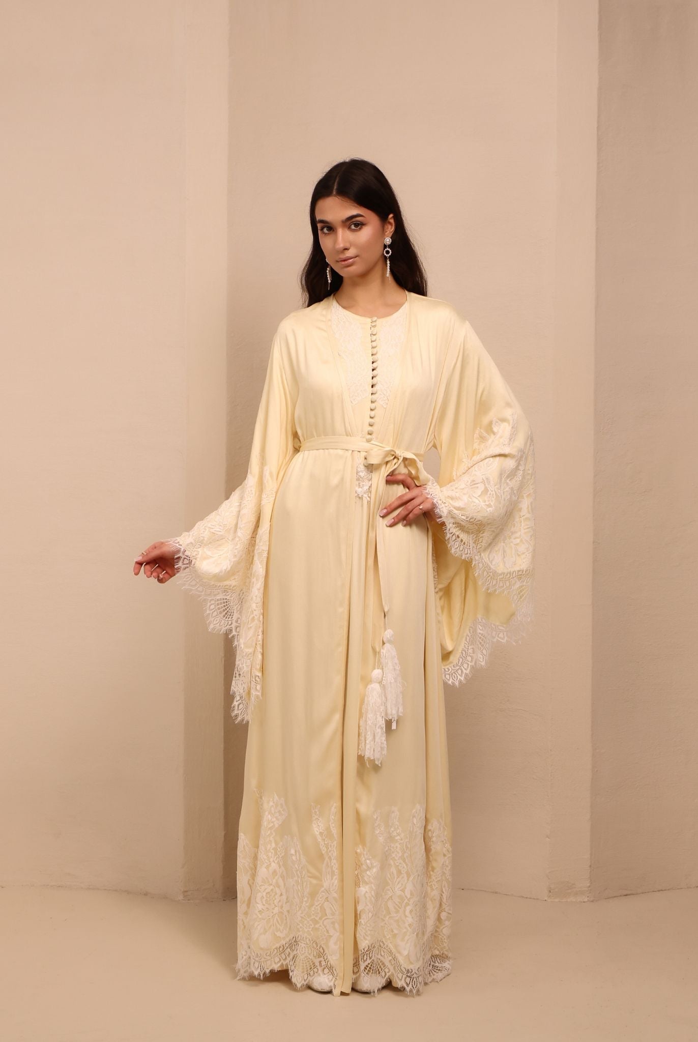 A frontal shot of the ensemble tied with a tassel belt, creating a cozy and feminine silhouette for home.