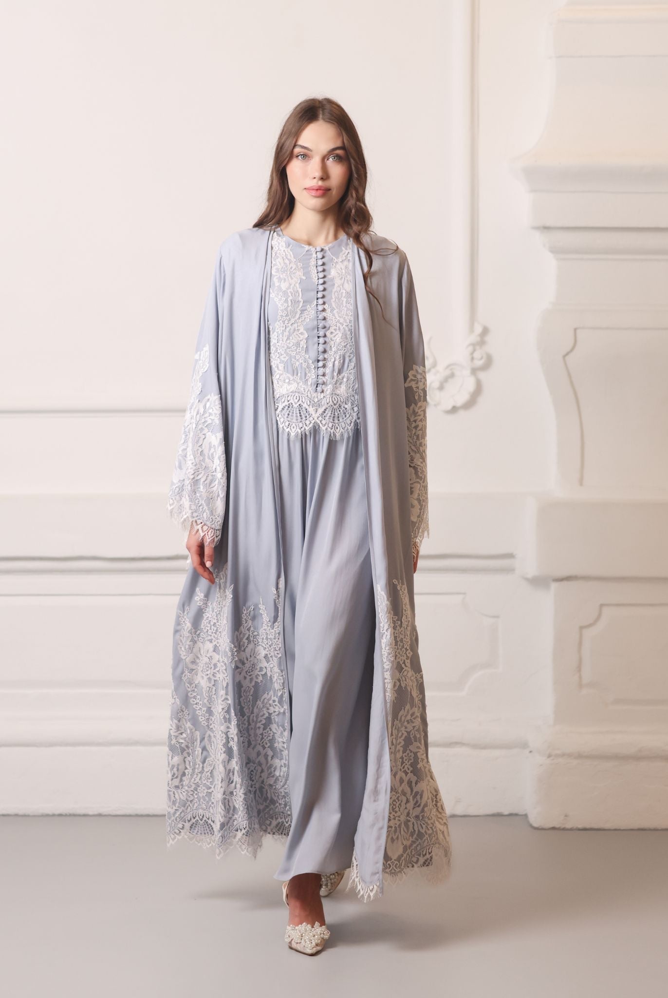 Full-length shot of a woman walking in a lace robe, showing the poetic movement of the viscose fabric.