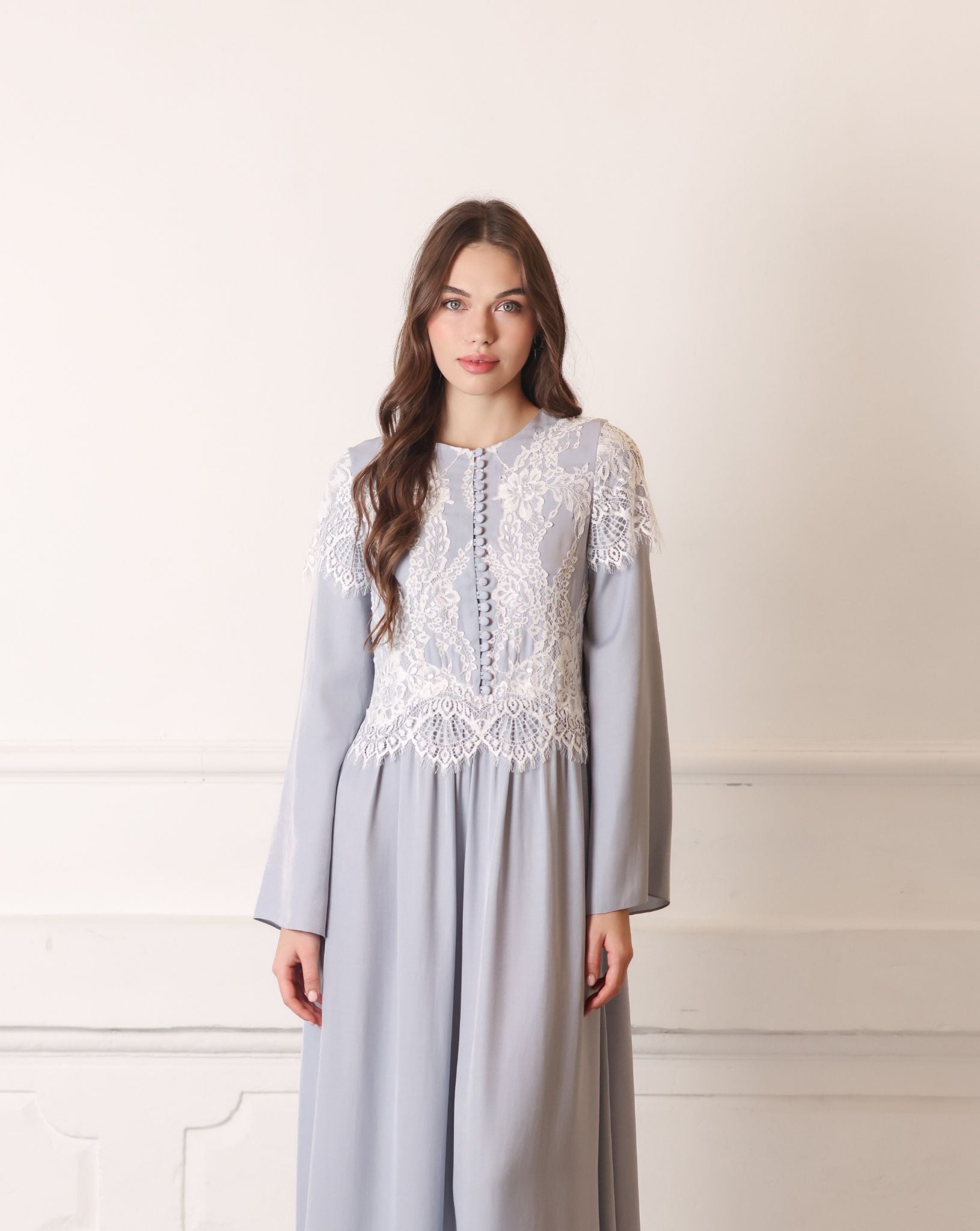 Mid-length shot of a nightgown, showcasing the high neckline and intricate lace details on the bodice.