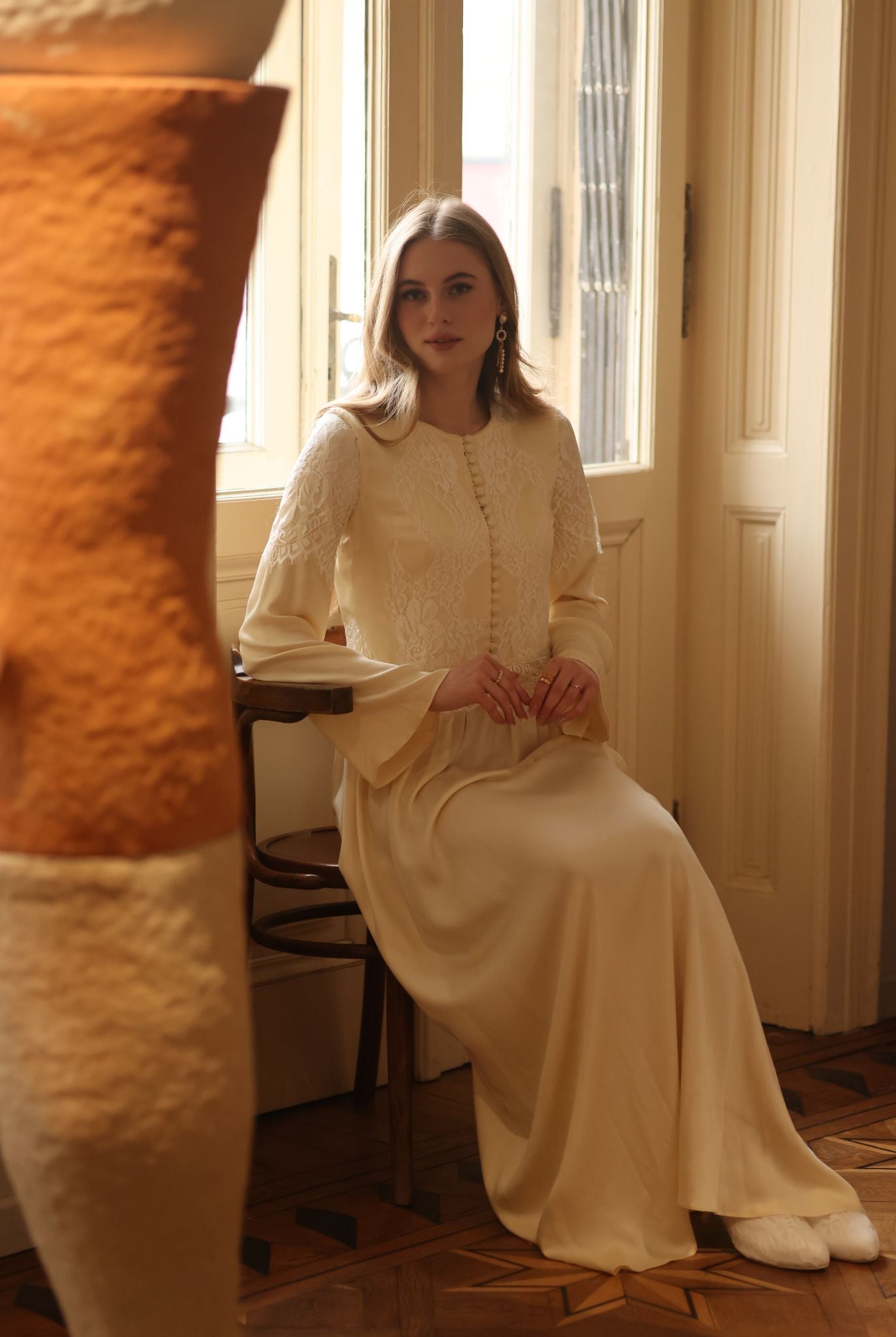 A seated shot of the modest nightdress, showcasing the relaxed fit and the natural softness of the material.