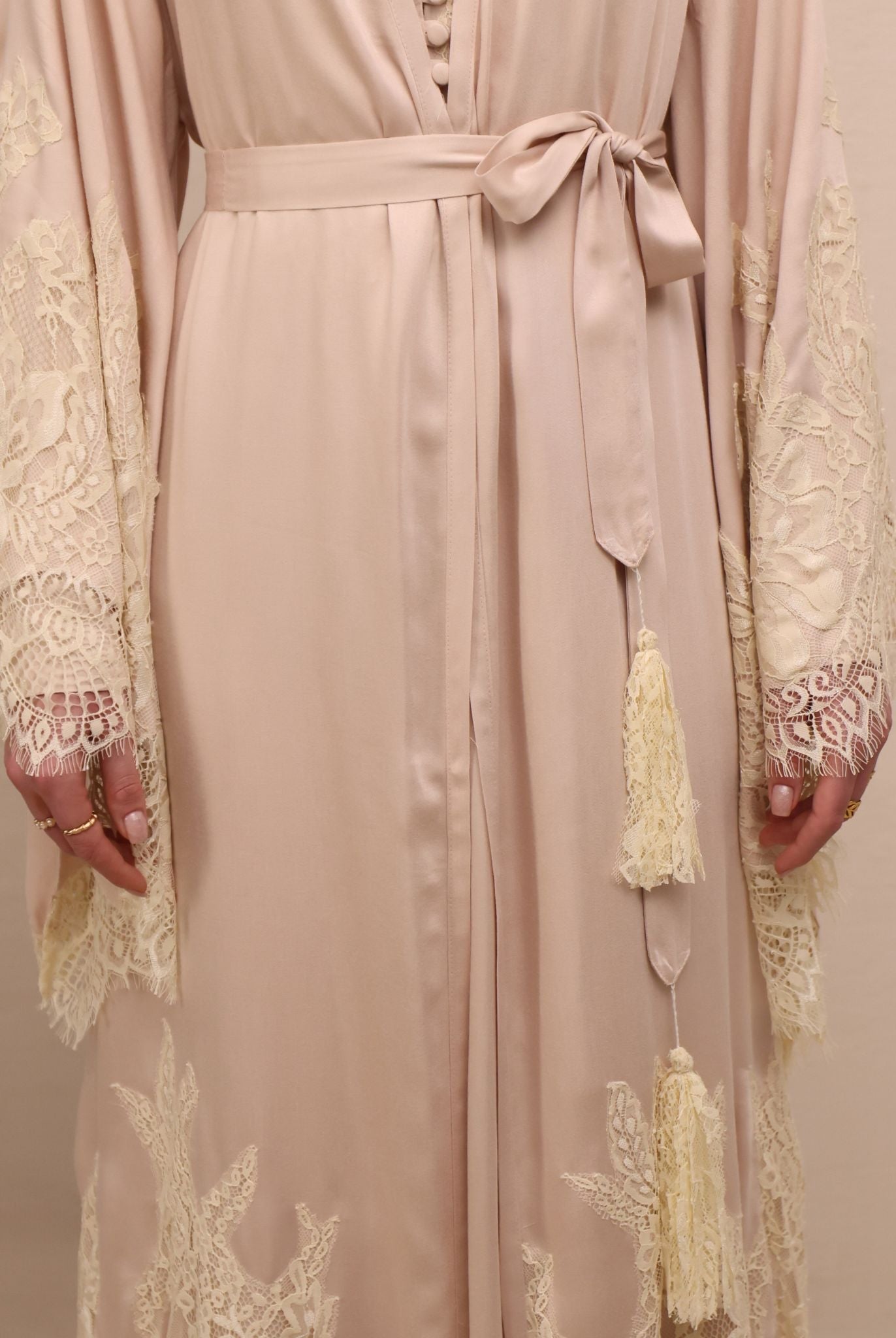 A mid-length shot focusing on the waist, highlighted by simple ties with tassels for an adjustable, relaxed fit.