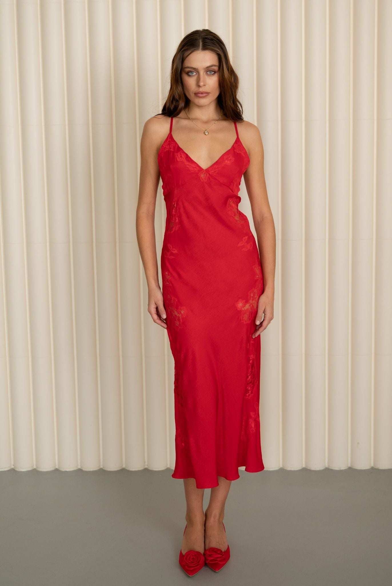 Front view of the long red nightdress, highlighting the fluid drape of the fabric and the elegant silhouette.