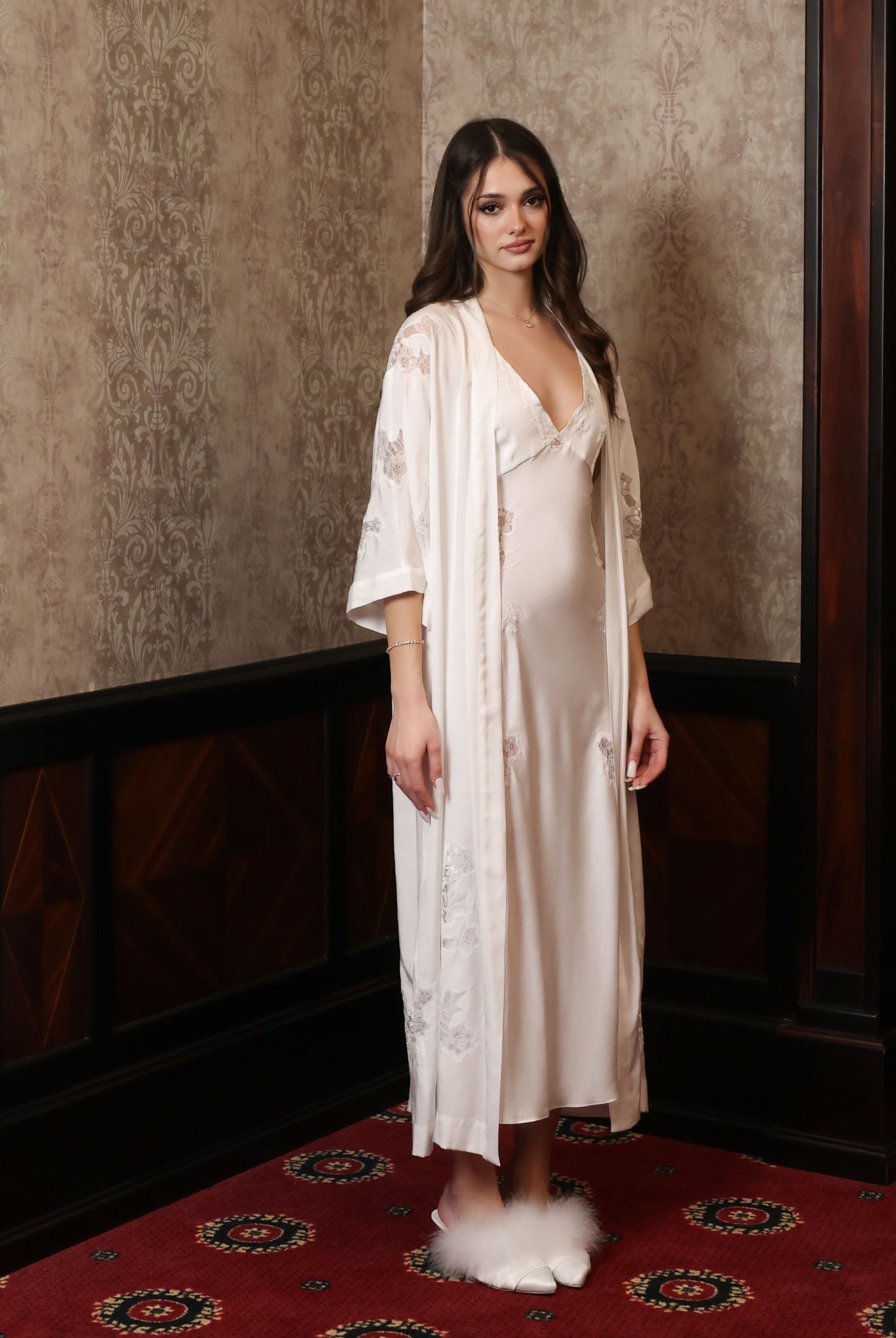An aesthetic full-height shot from the side, highlighting the soft train of the robe and the elegant silhouette.
