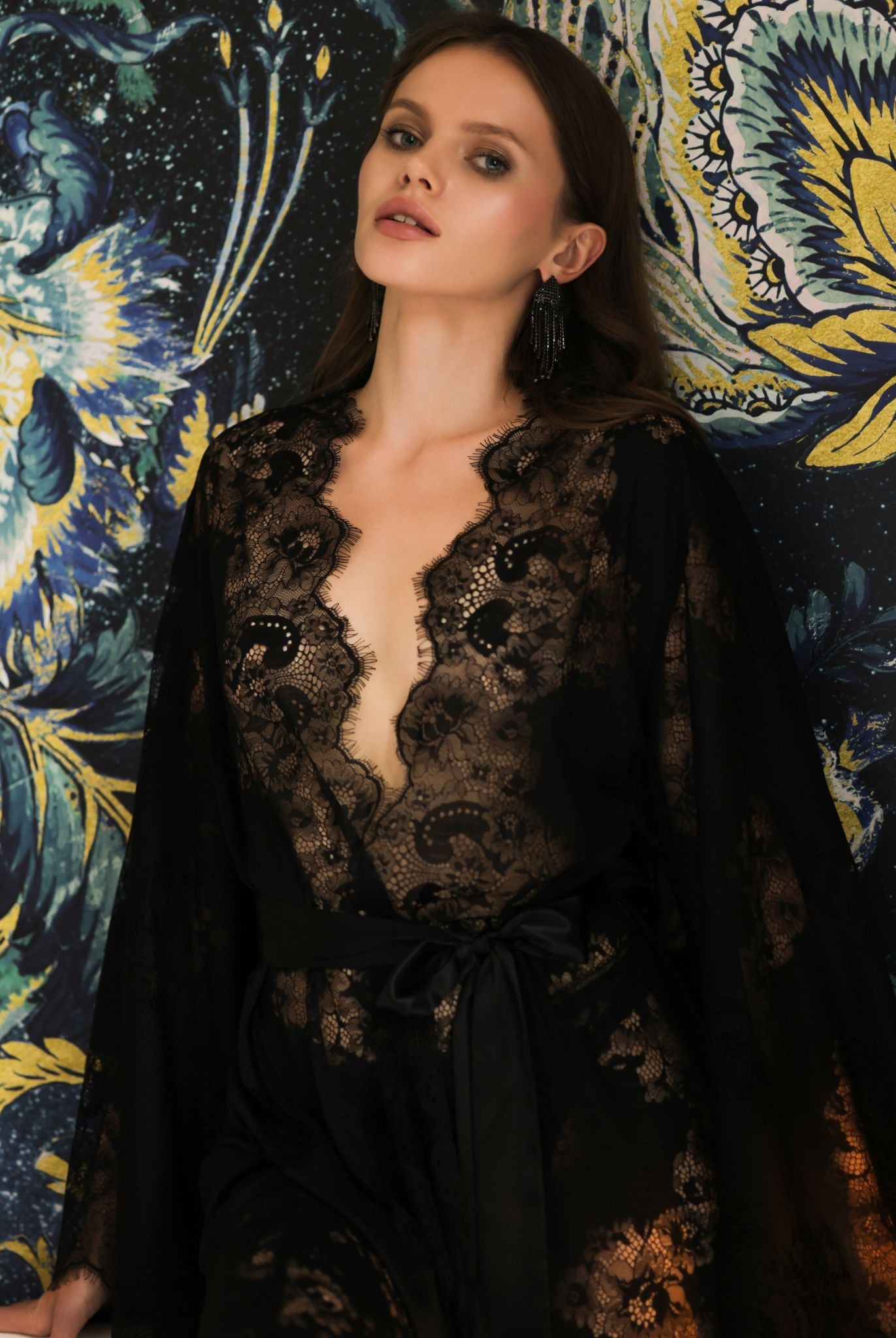 Waist-up shot focusing on the exquisite floral lace patterns and the deep V-neckline of the black evening robe.
