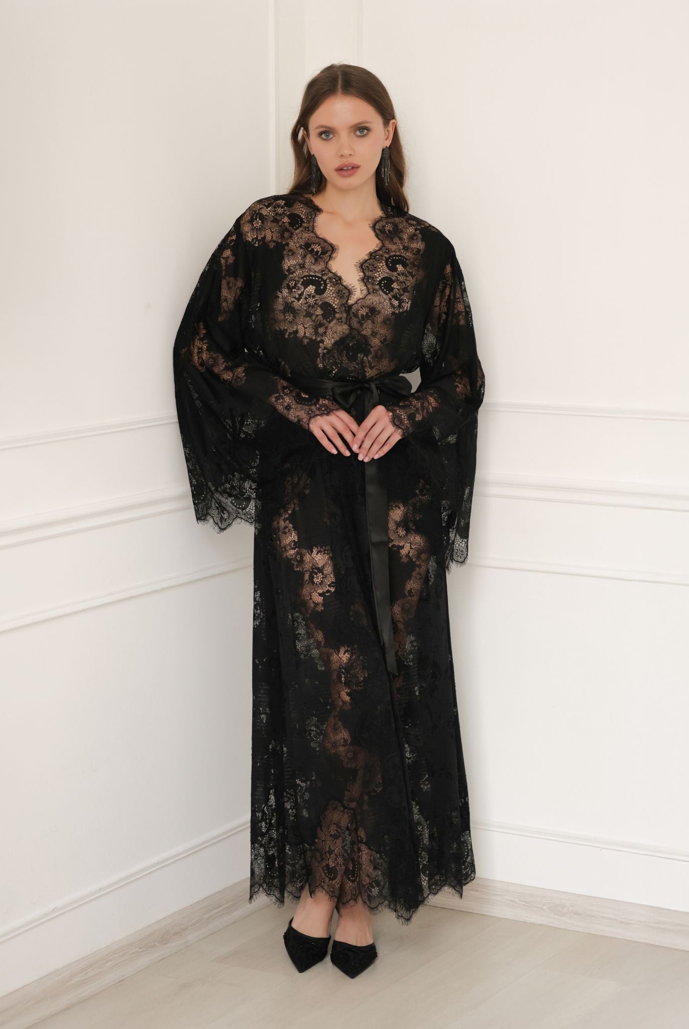 Static full-length view of the long black lace garment, showcasing its regal silhouette and lightweight material.