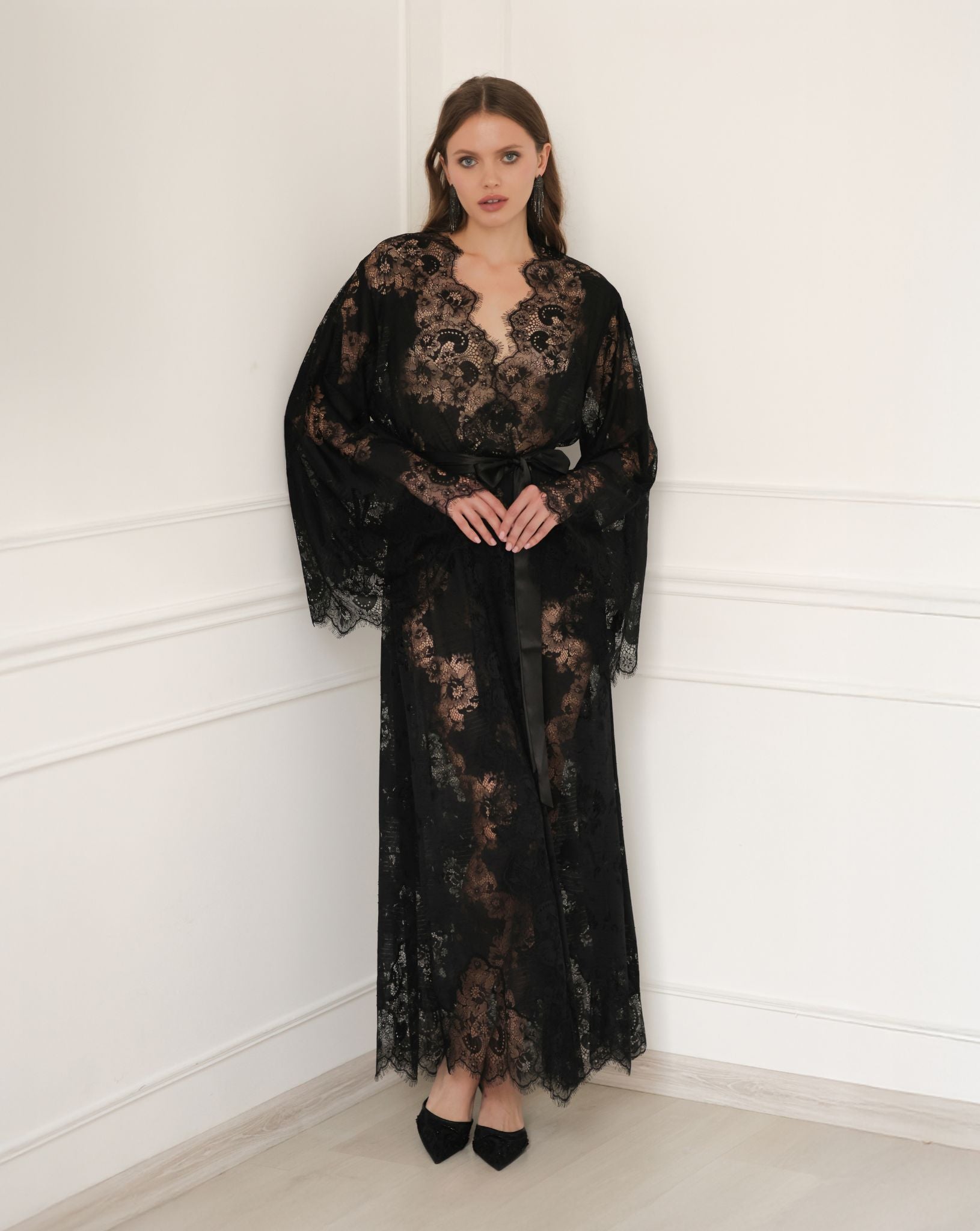Static full-length view of the long black lace garment, showcasing its regal silhouette and lightweight material.