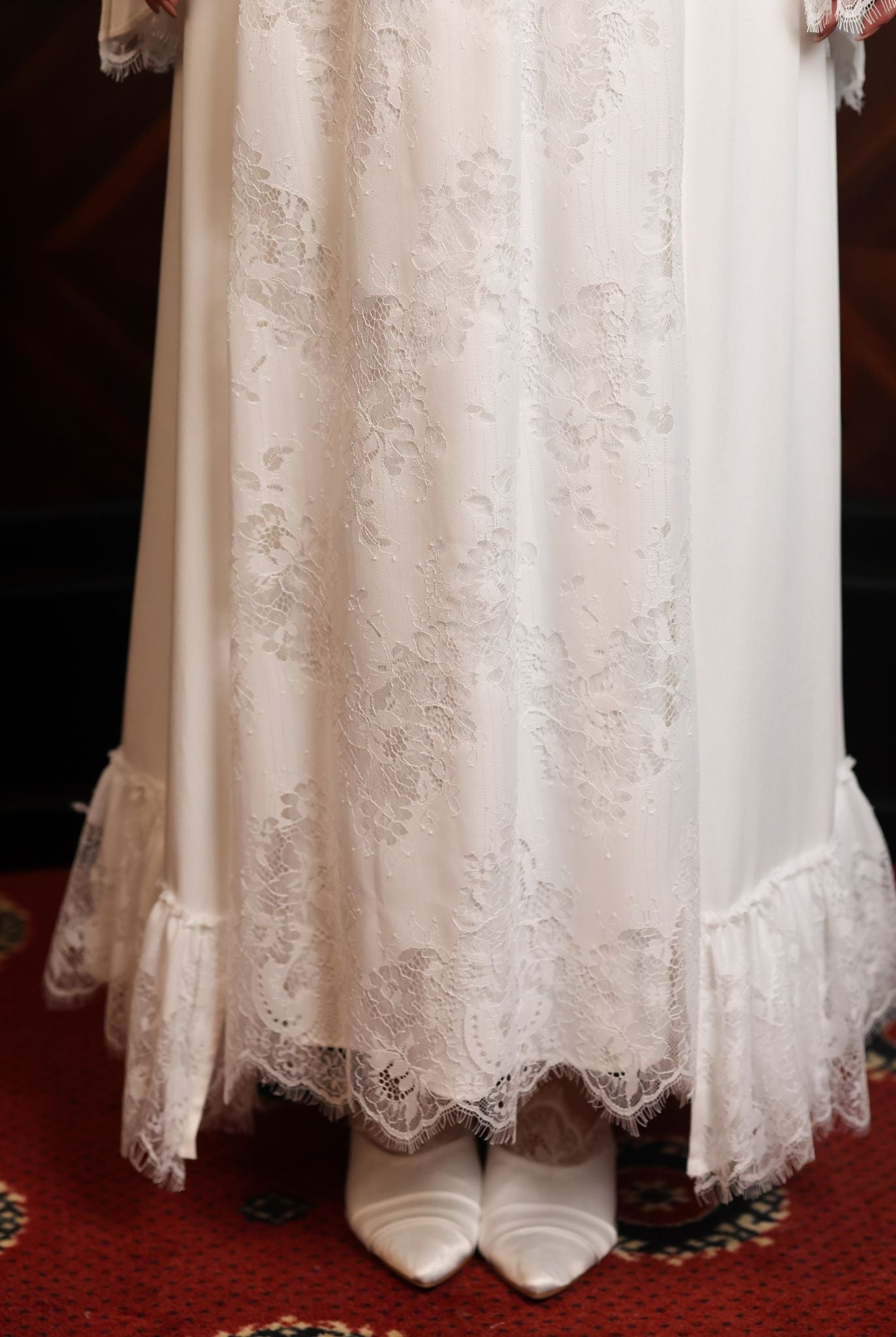 A lower-body shot showcasing the lace skirt and the graceful movement of the hem near the footwear.