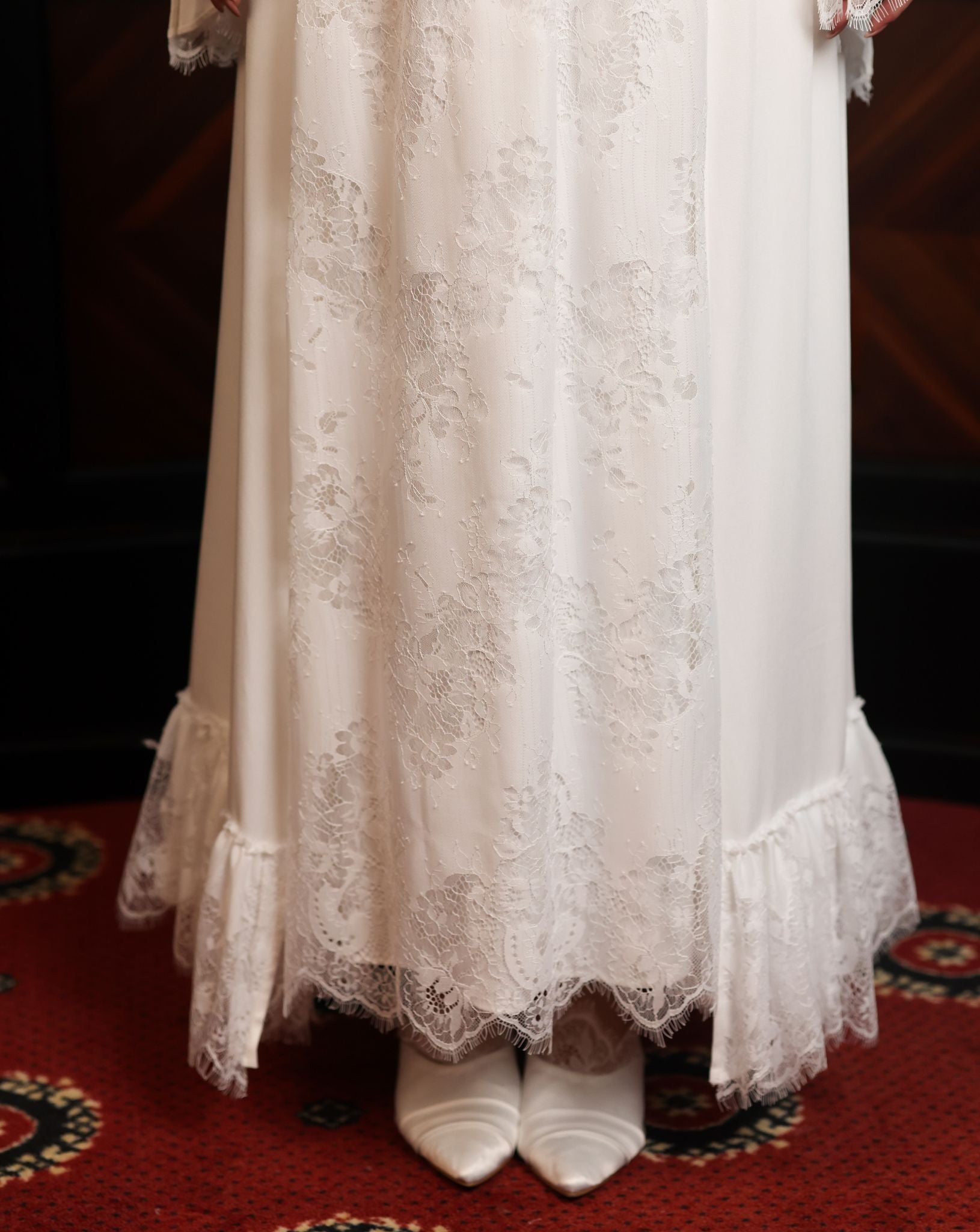 A lower-body shot showcasing the lace skirt and the graceful movement of the hem near the footwear.