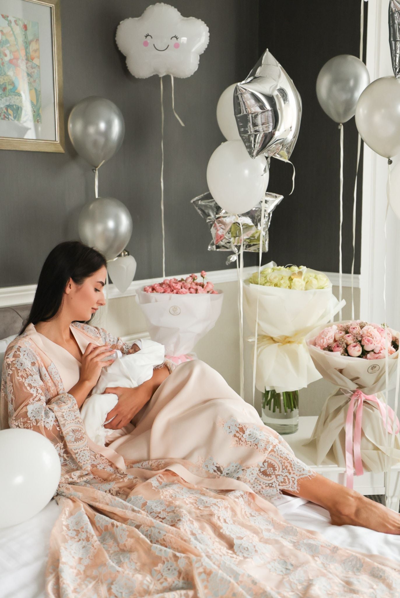 Peaceful moment on a bed with a baby, featuring the romantic aesthetic and soft textures of the motherhood ensemble.
