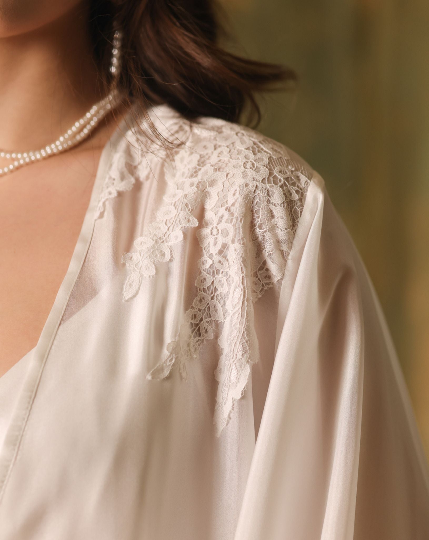 Close-up of the robe's shoulder, showcasing the intricate lace accents and the airy texture of mulberry silk.