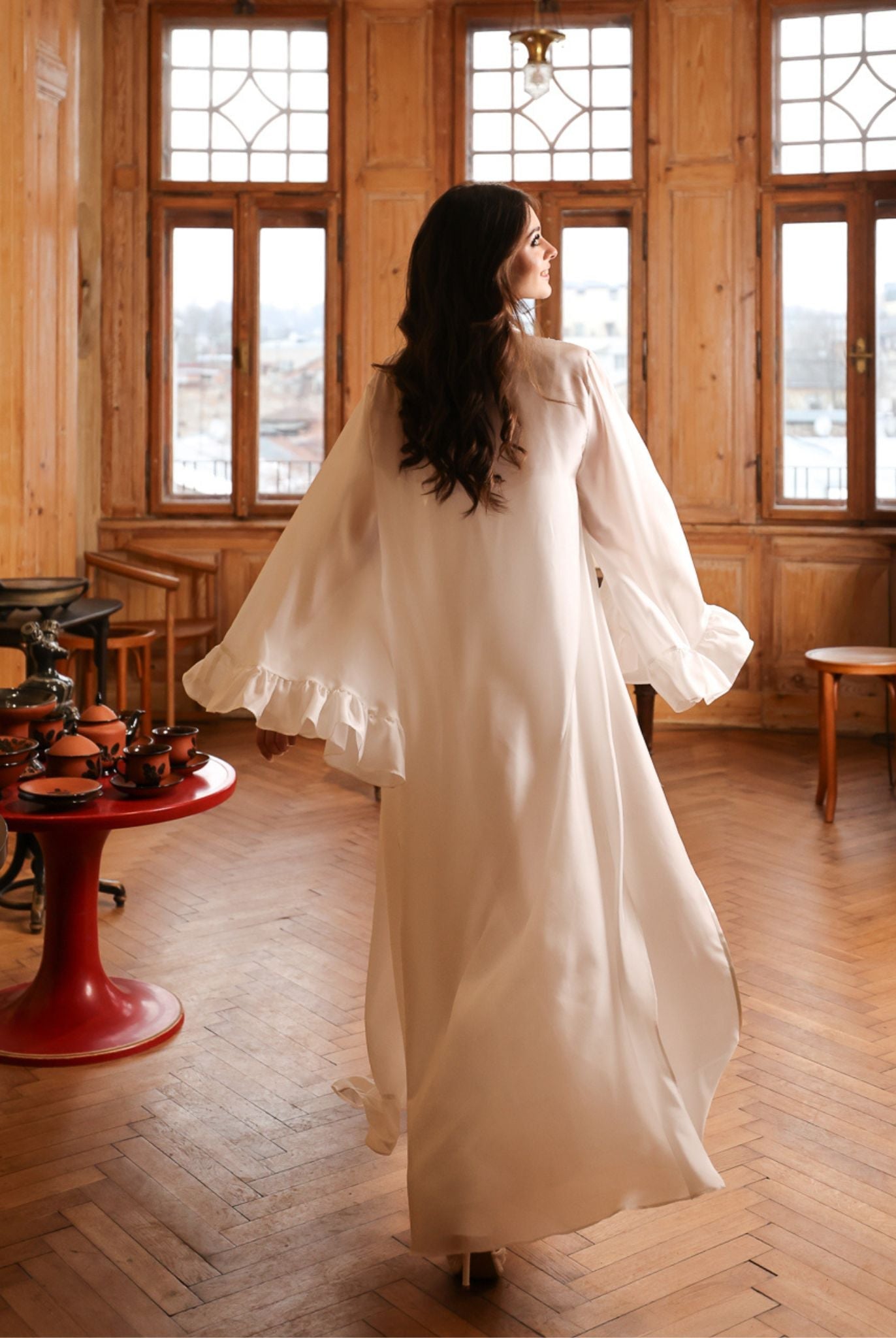 Capturing the poetic movement of a Silk Robe and Nightgown Set from behind, featuring ethereal ruffled edges.