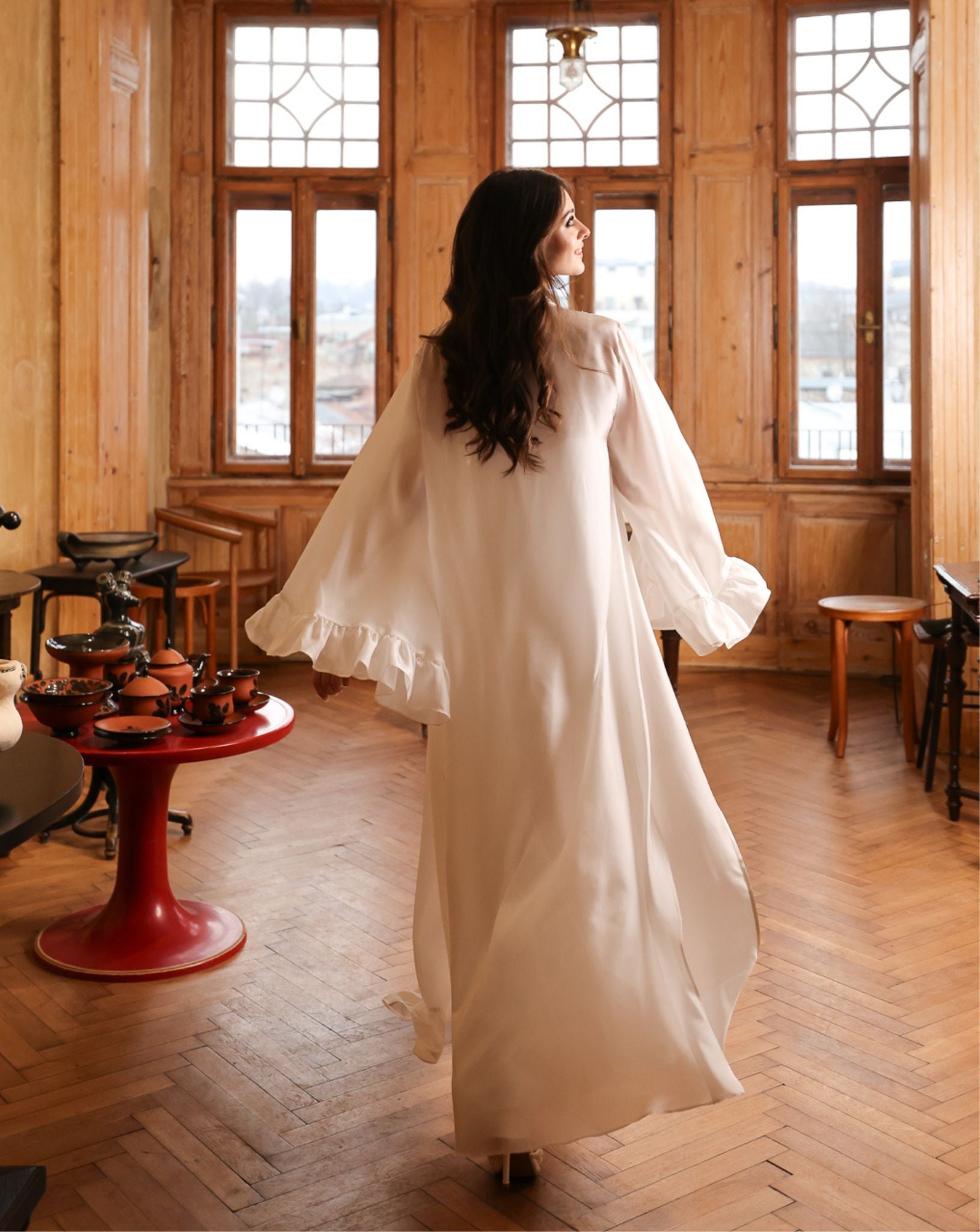 Capturing the poetic movement of a Silk Robe and Nightgown Set from behind, featuring ethereal ruffled edges.