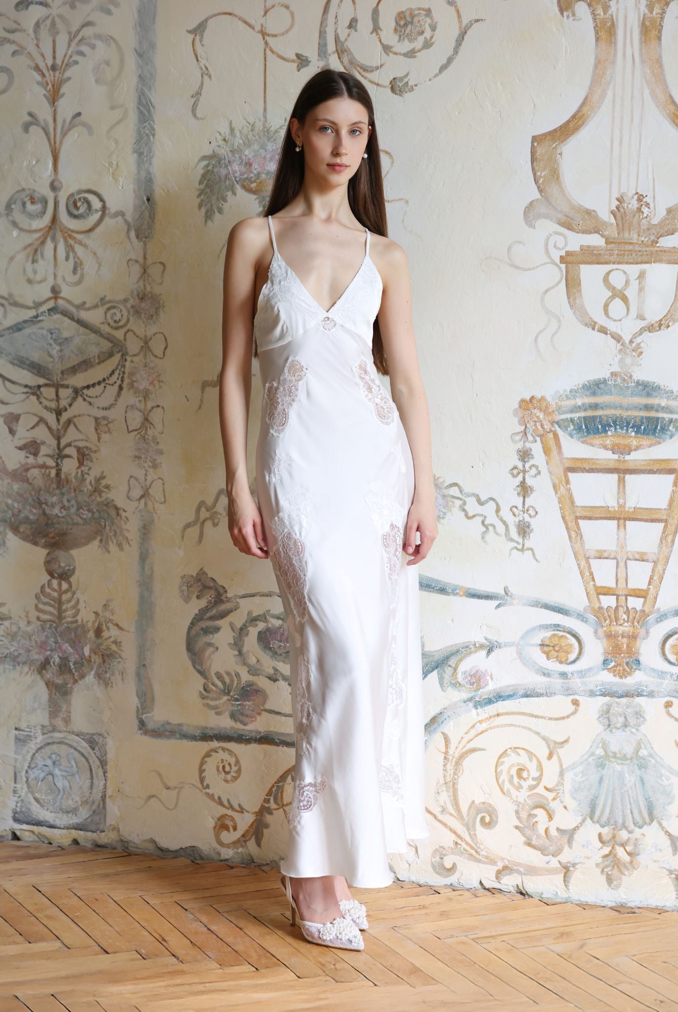 Frontal pose in a white silk-like nightdress with intricate lace cutouts, emphasizing a flattering and serene silhouette.