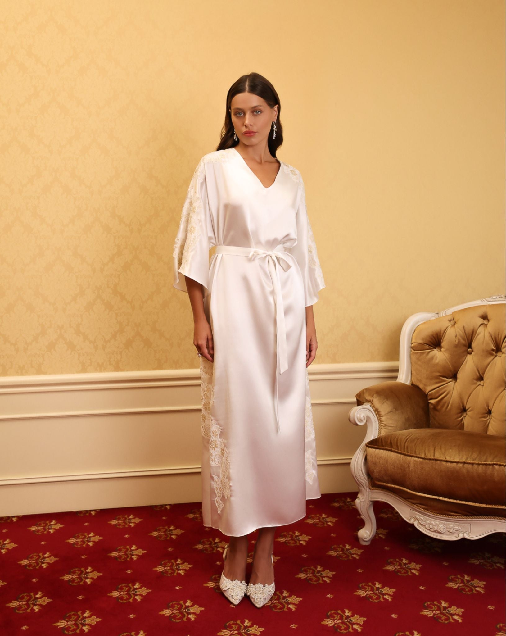 Full-length shot of model wearing embroidered white kaftan in gold interior – KÂfemme