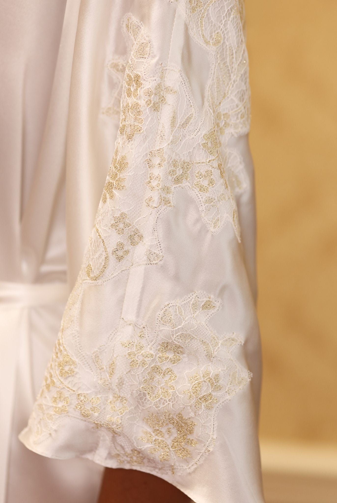 Close-up of gold floral embroidery on white satin kaftan – KÂfemme