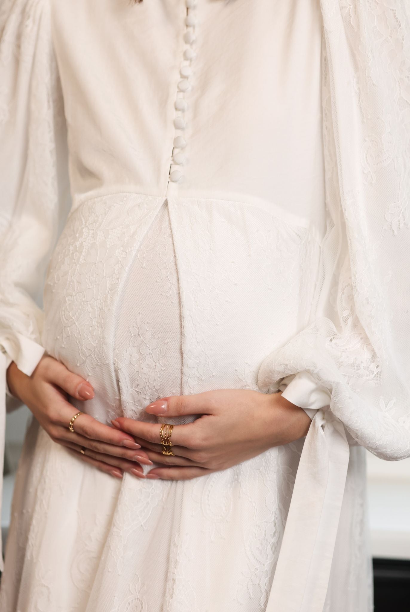 Close-up from neck to waist, showing the satin buttons that provide discreet and comfortable breastfeeding access.
