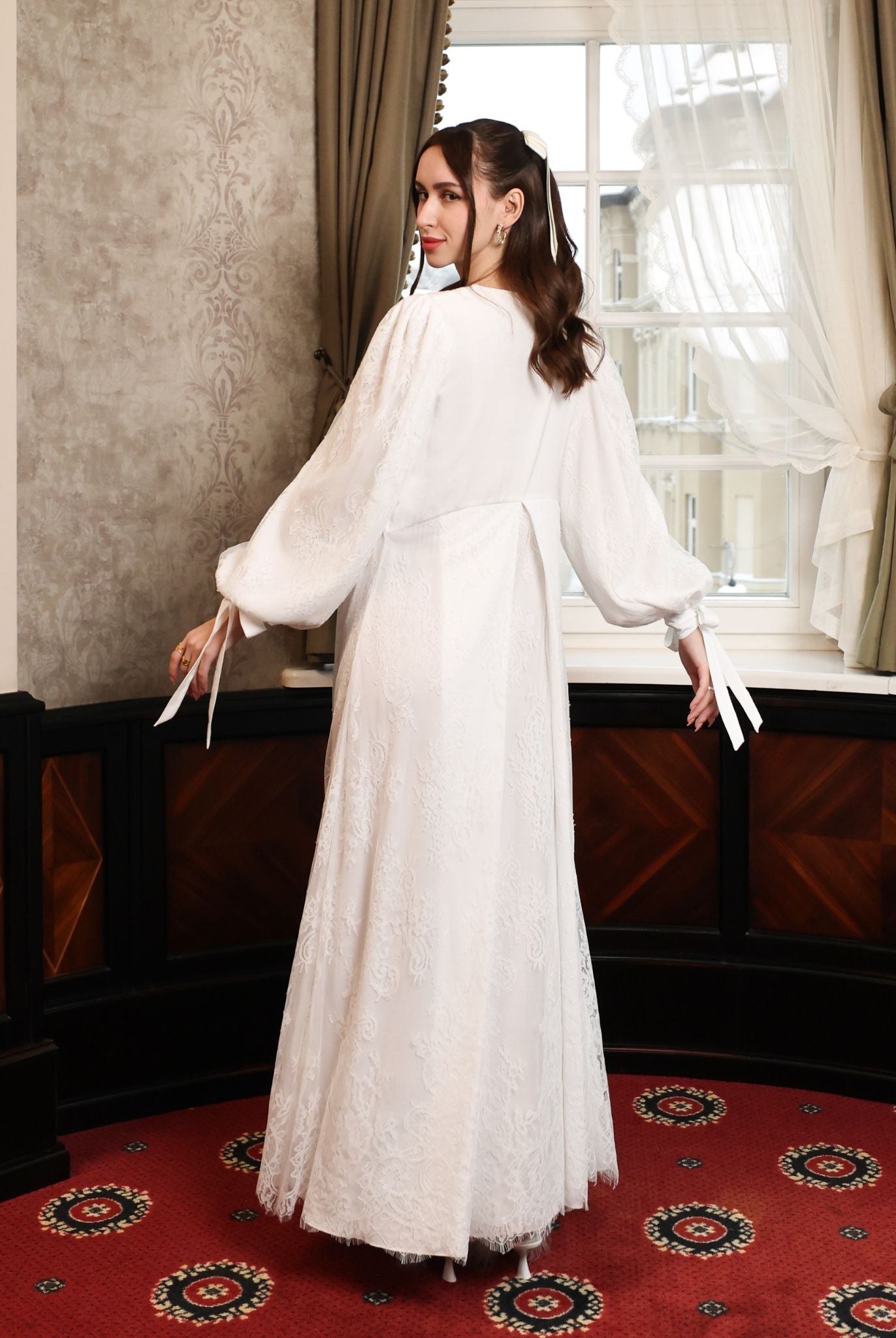 : A dynamic view showcasing the lace-covered back and the movement of the two-layered lace skirt during a turn.