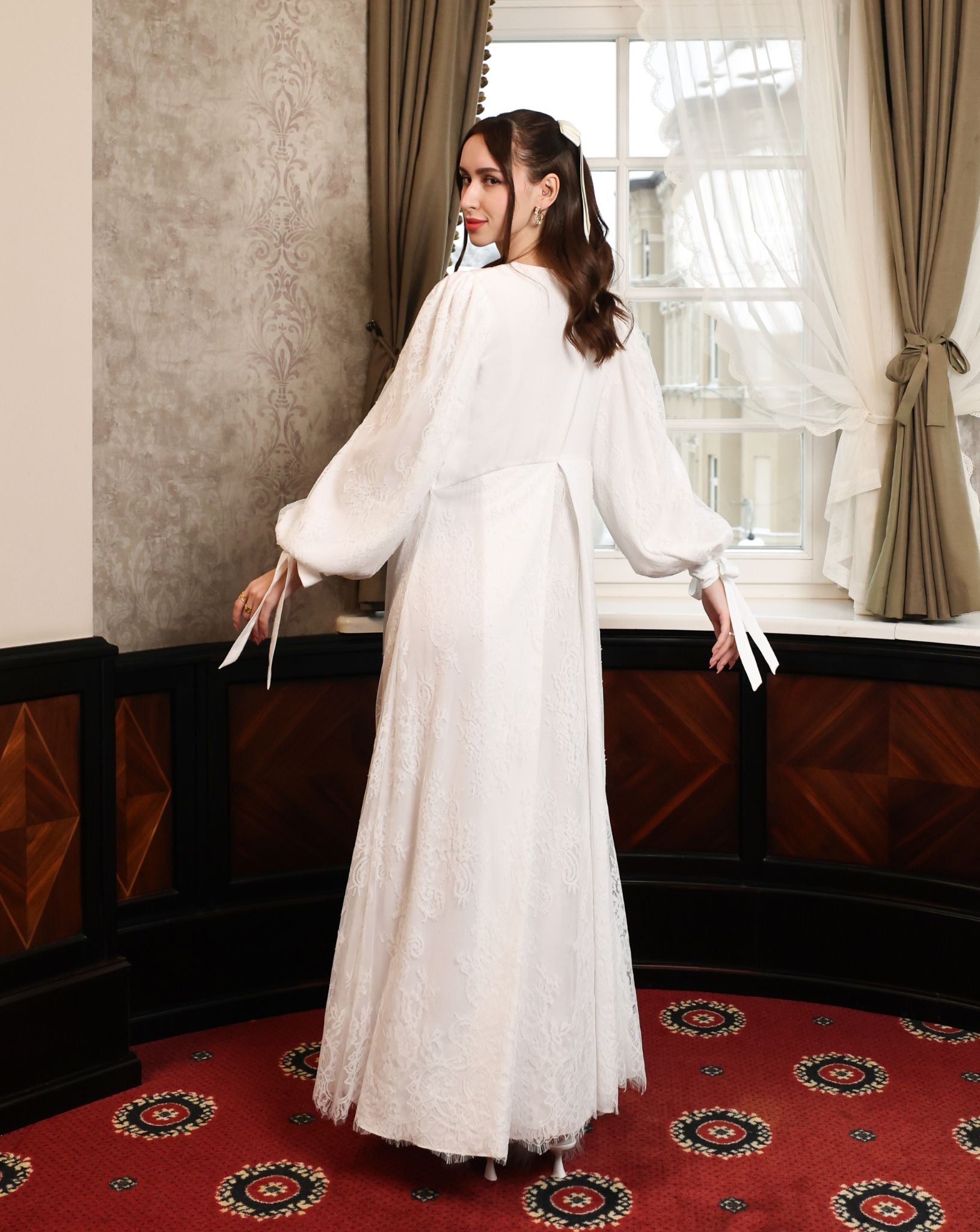 : A dynamic view showcasing the lace-covered back and the movement of the two-layered lace skirt during a turn.