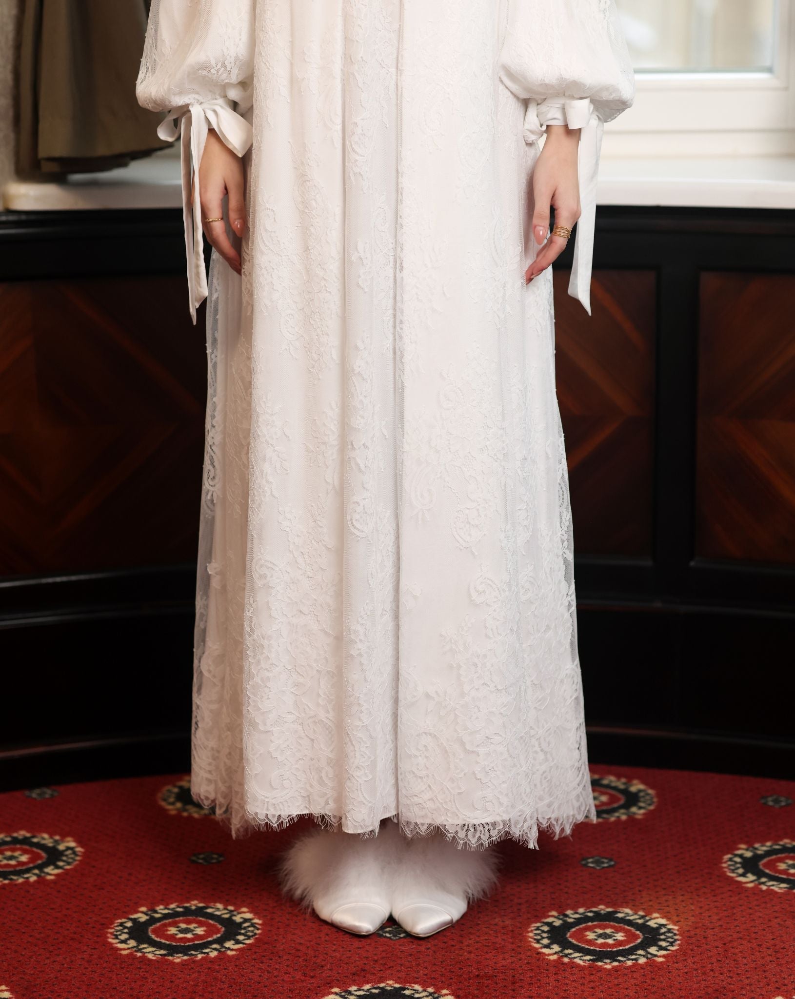 A shot from the waist down, focusing on the airy lace layers of the skirt and the timelessly feminine silhouette.