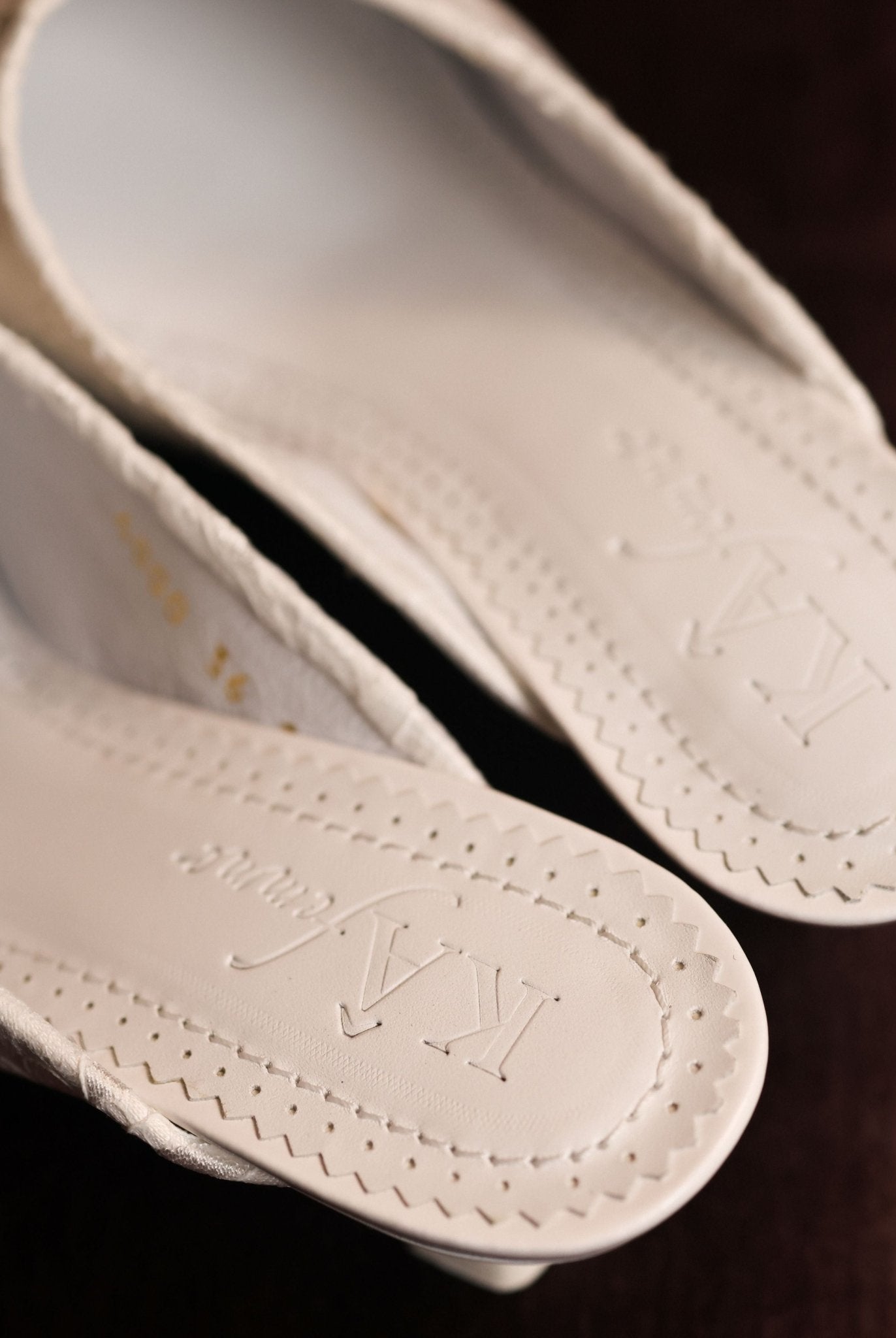 Close-up of the genuine leather insole featuring the brand logo, emphasizing the refined quality of the Slippers.