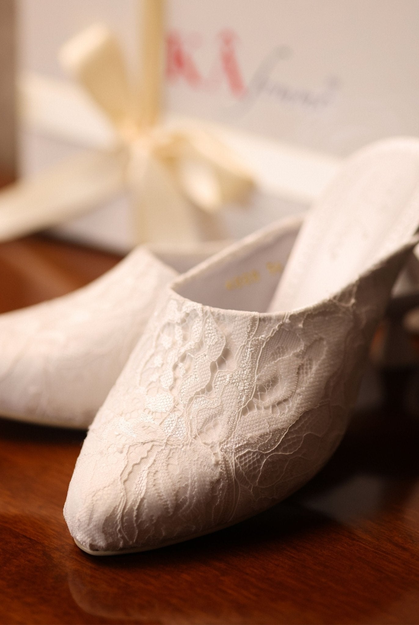 Close-up shot near the packaging, focusing on the carefully balanced elements and the soft lace adornment.