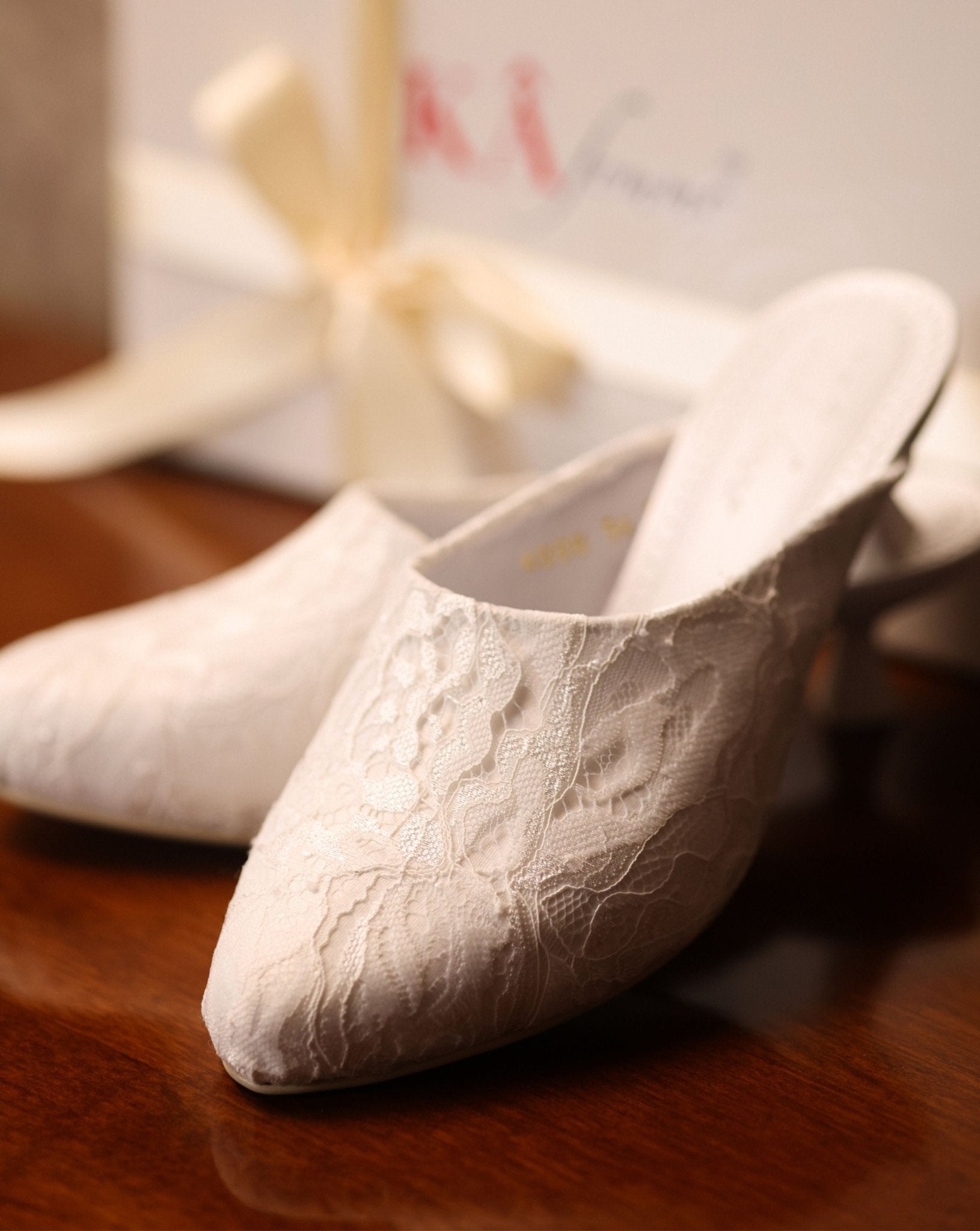 Close-up shot near the packaging, focusing on the carefully balanced elements and the soft lace adornment.