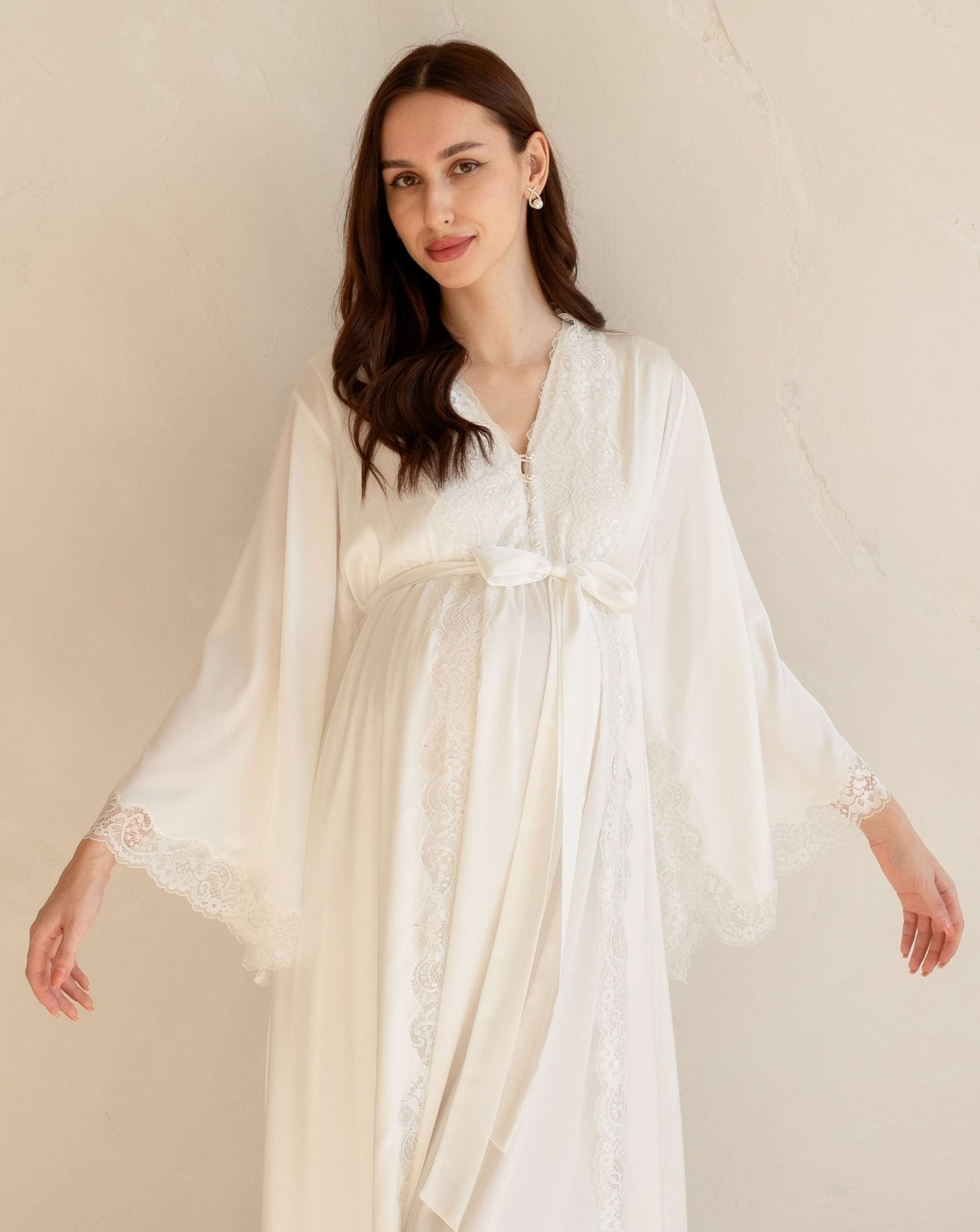 Mid-length view of a white maternity ensemble featuring