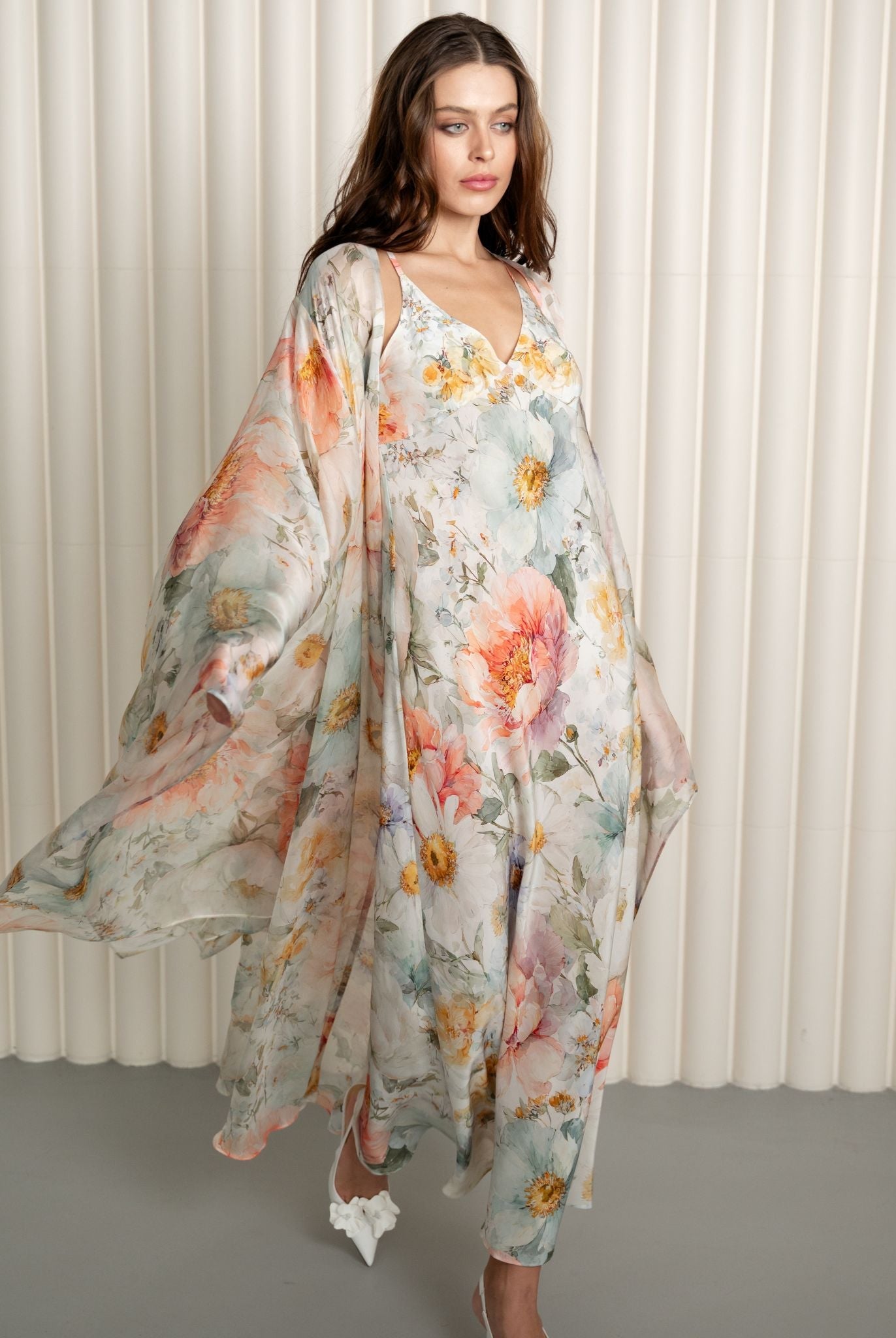 Silk floral robe flowing over pastel nightgown ensemble