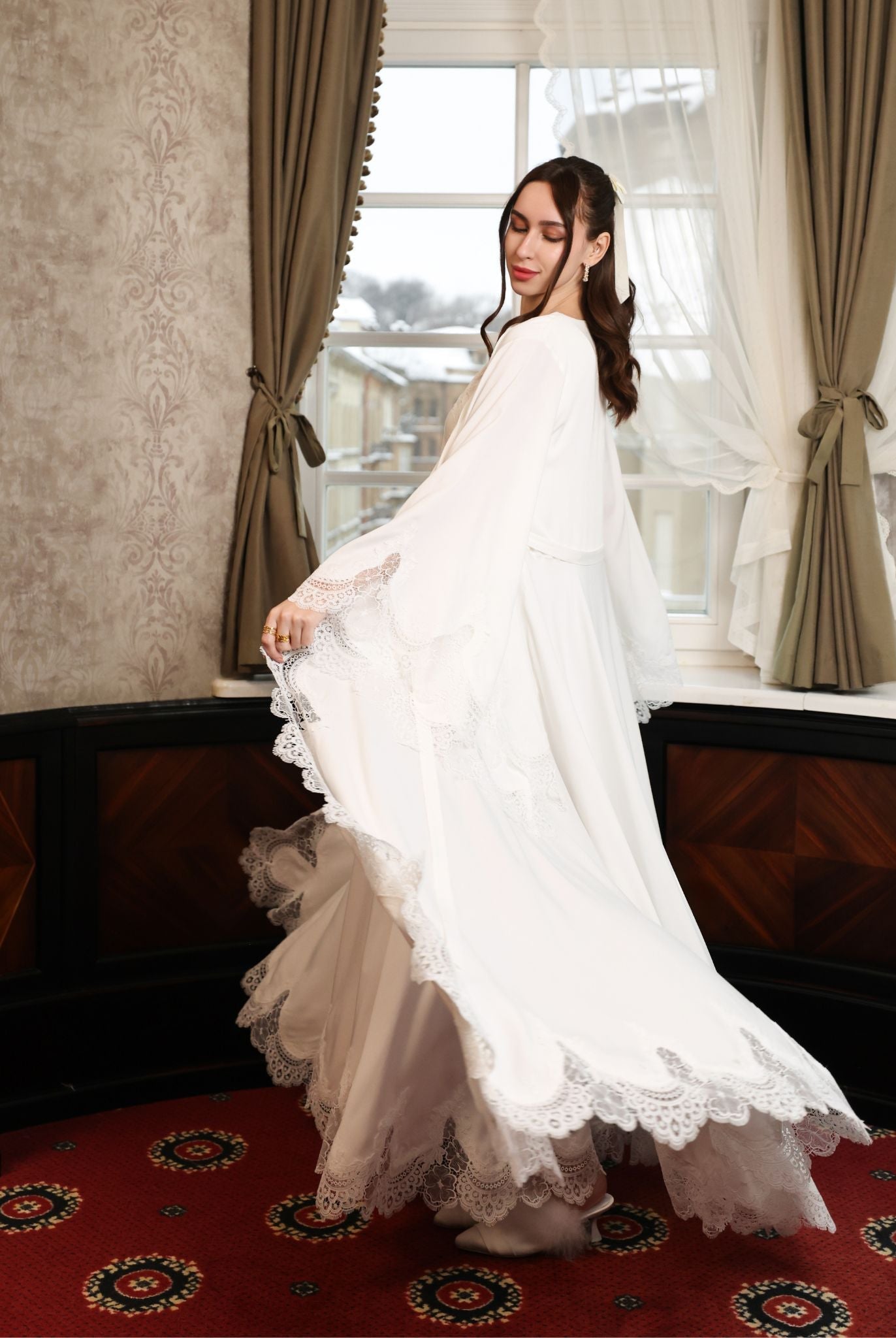 Capturing the visual poetry of the moving robe, illustrating the lightness and femininity of the design.