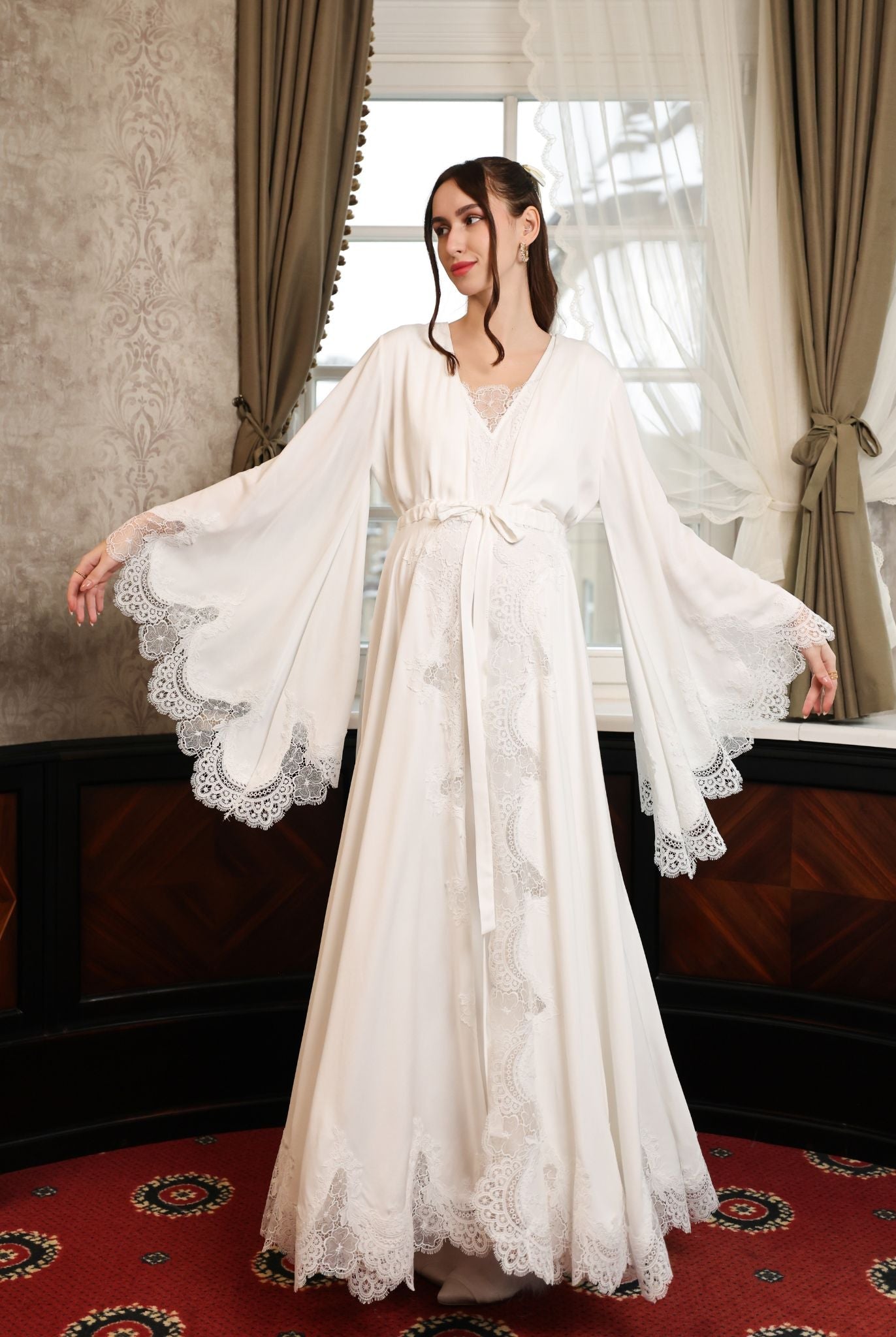 A pose in the Cotton Robe and Nightgown Set with lifted flared sleeves to demonstrate their impressive volume.
