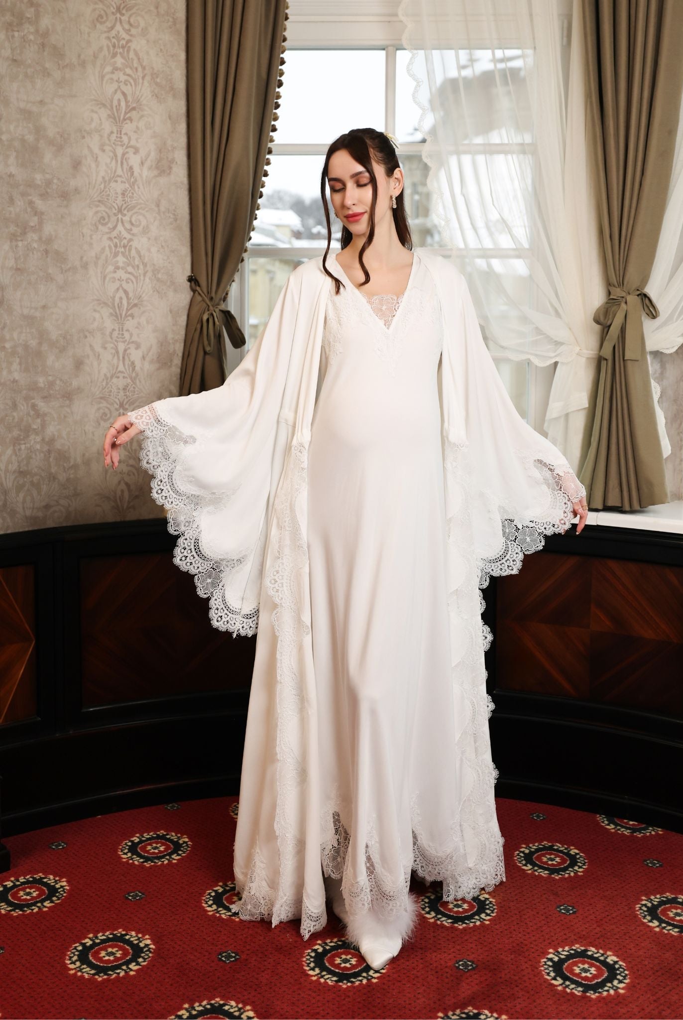 The robe worn open without a sash, focusing on the gracefully flared sleeves and intricate lace embellishment.