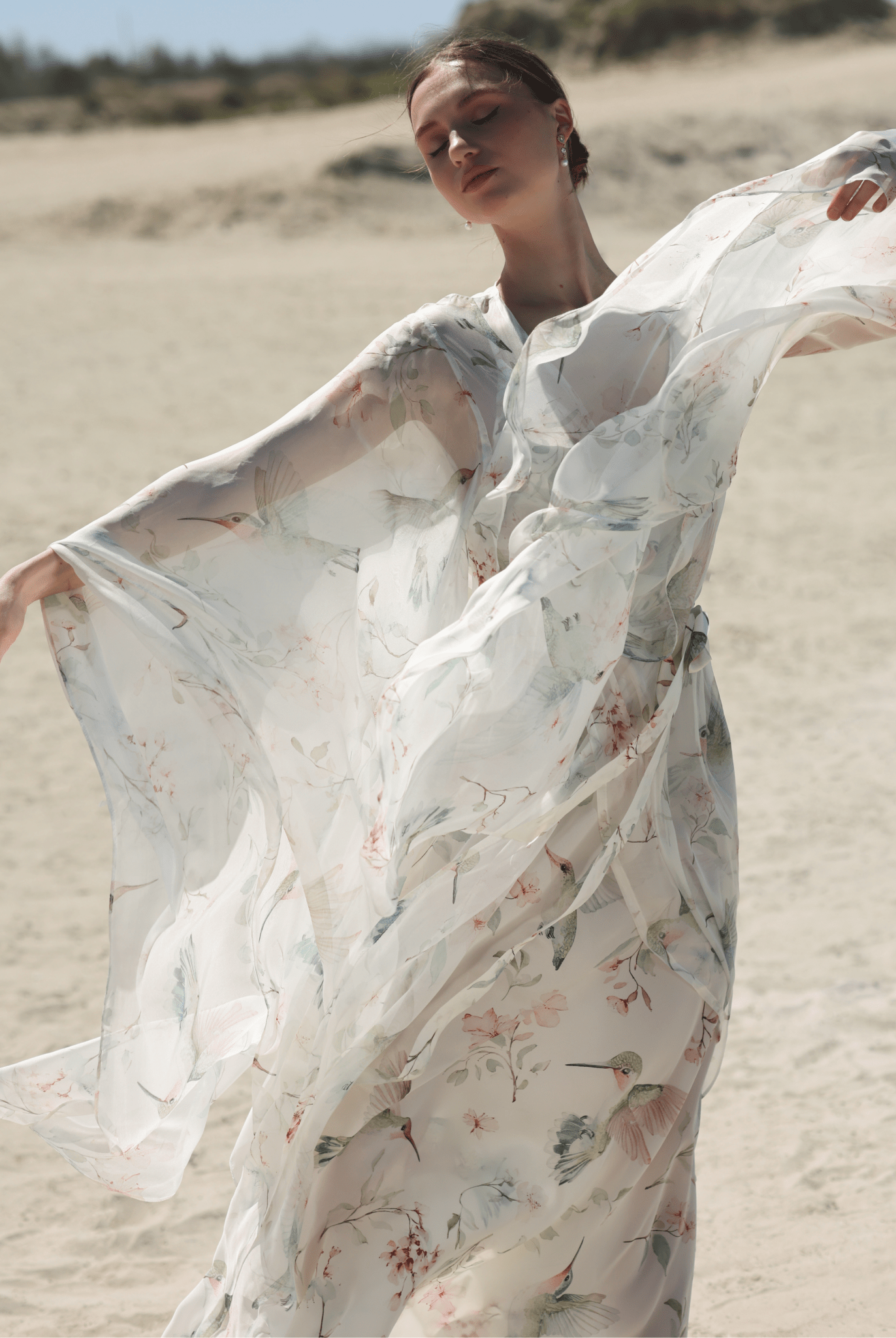 A dynamic view of the attire, highlighting the artistic floral design and the graceful movement of the pure silk fabrics.