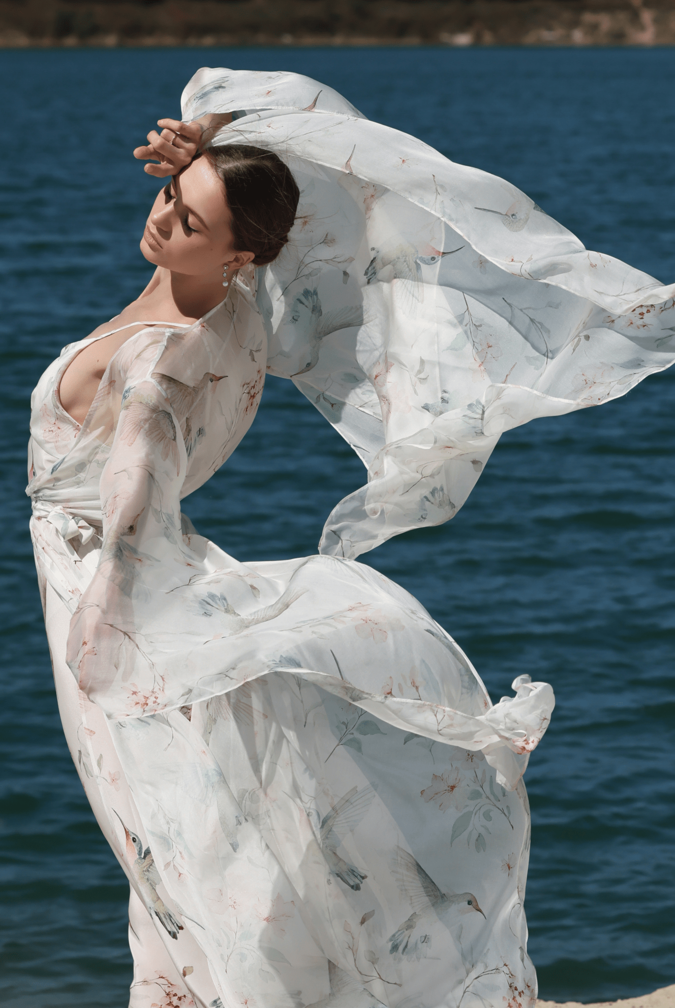 A poetic shot of the Silk Robe and Nightgown Set in motion, capturing the weightless silk chiffon as it flows by the water.