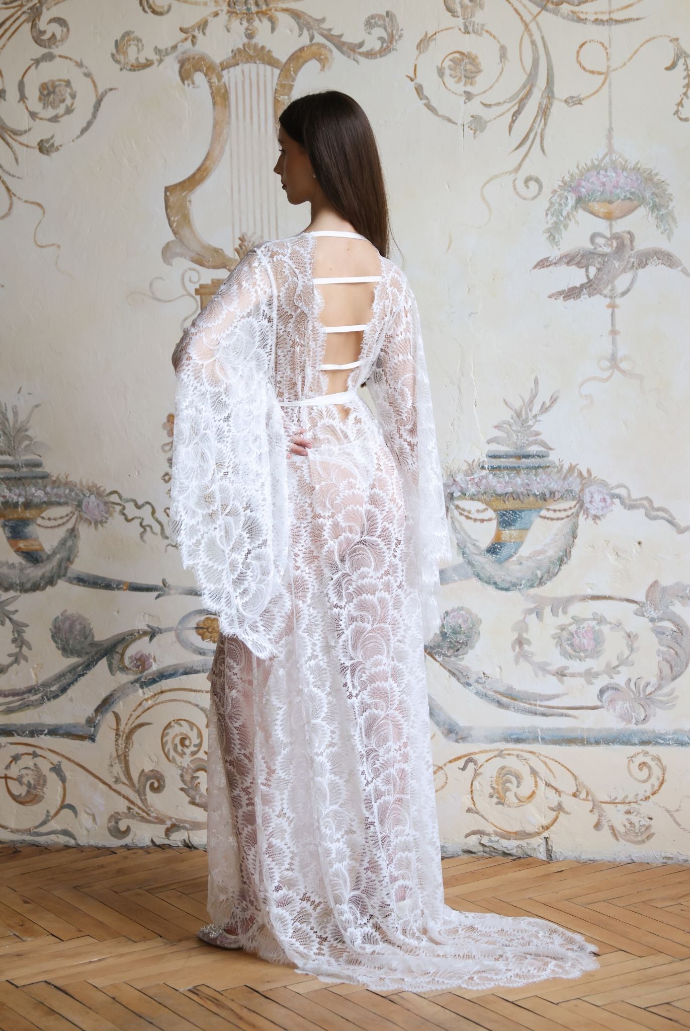 Rear view of the Lace Bridal Robe, showcasing the dramatic long train and refined back strap details.