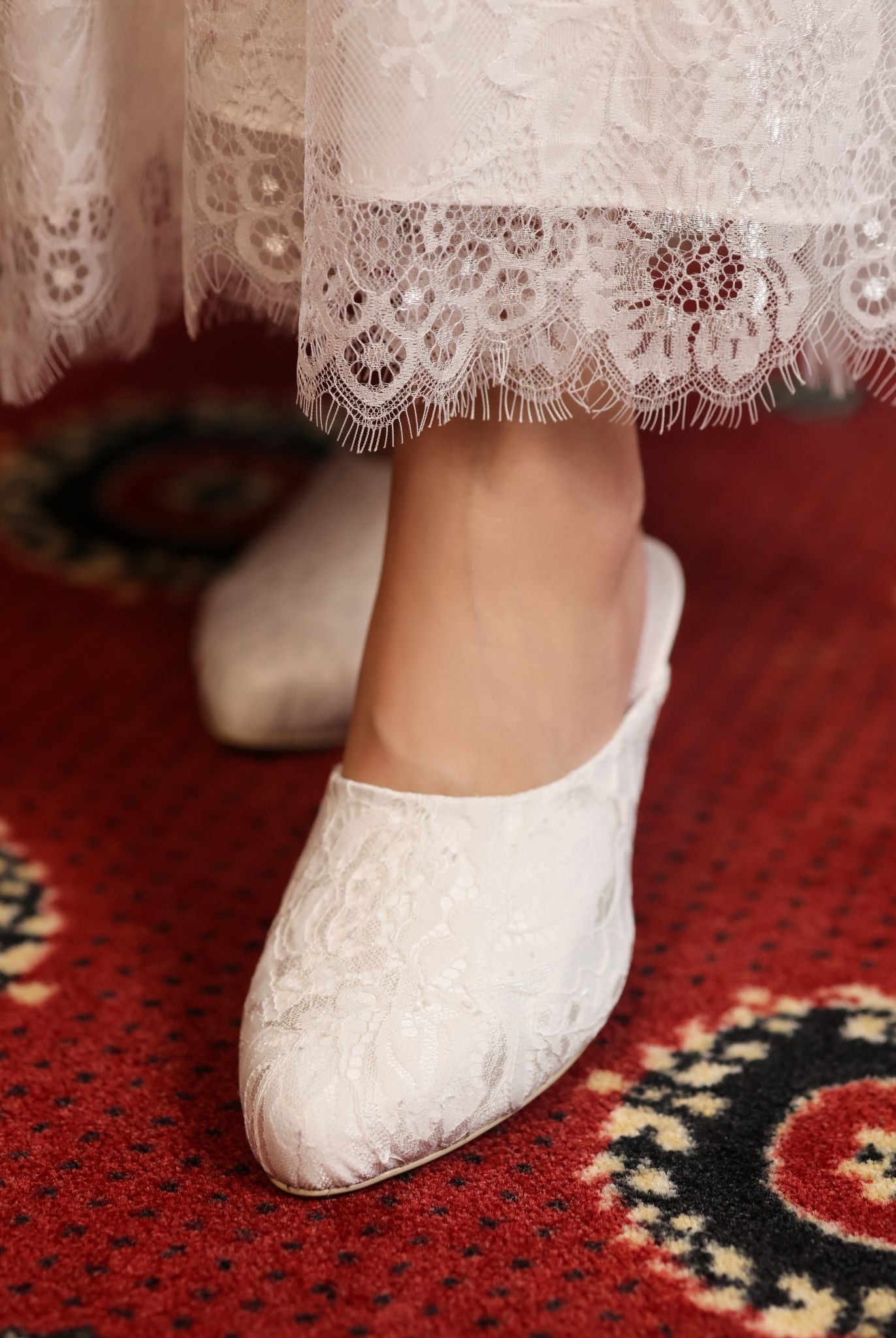 Detailed shot of the lace hem and footwear, capturing the timelessly feminine and light feel of the layered skirt.