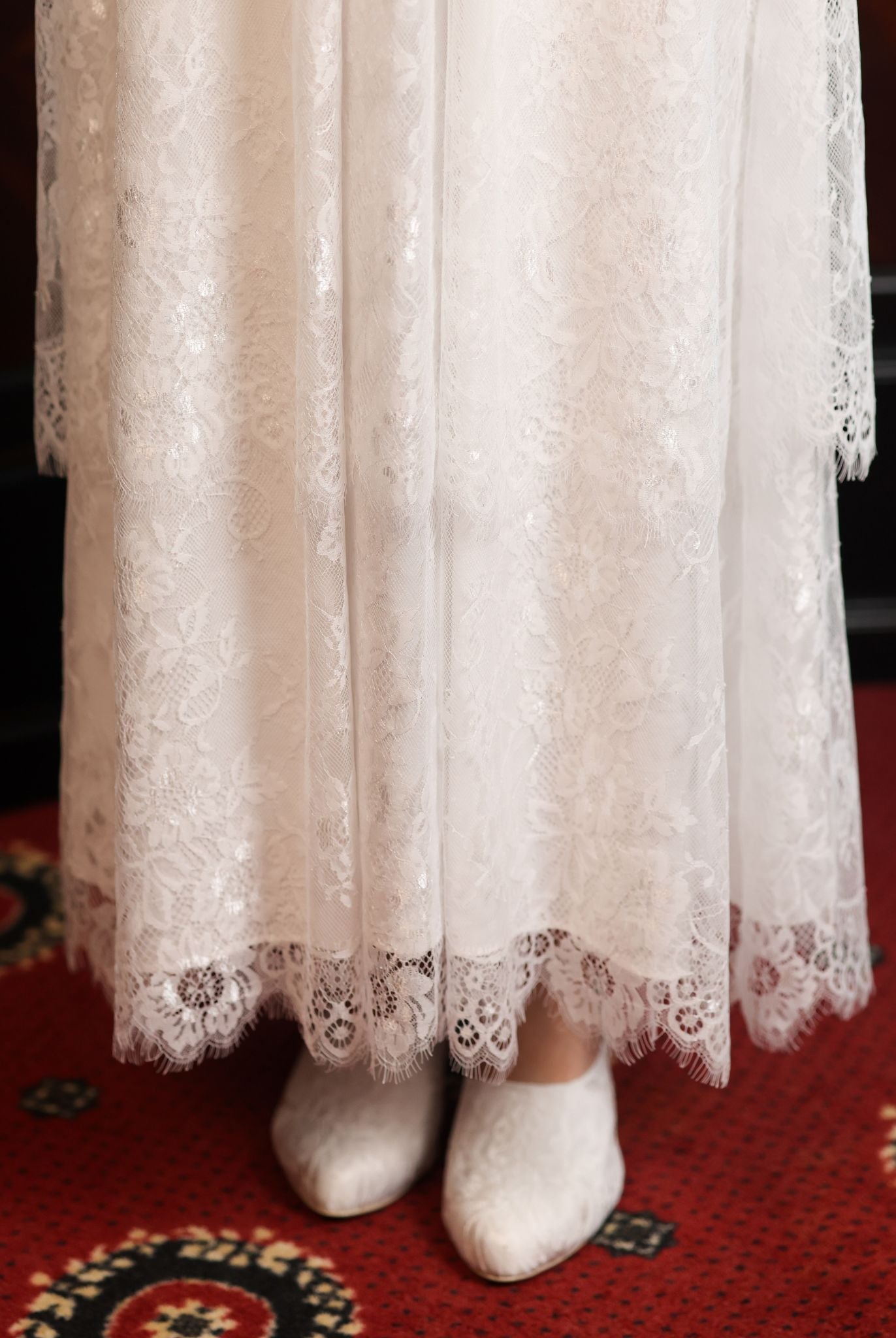Close-up of the Modest Lounge Dress skirt, highlighting the depth of the two layers of lace and its romantic texture.