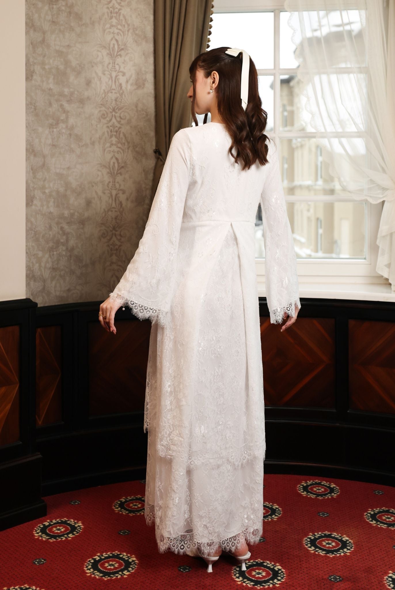 Rear view from the head down, showcasing the intricate lace that continues across the back for a romantic feel.