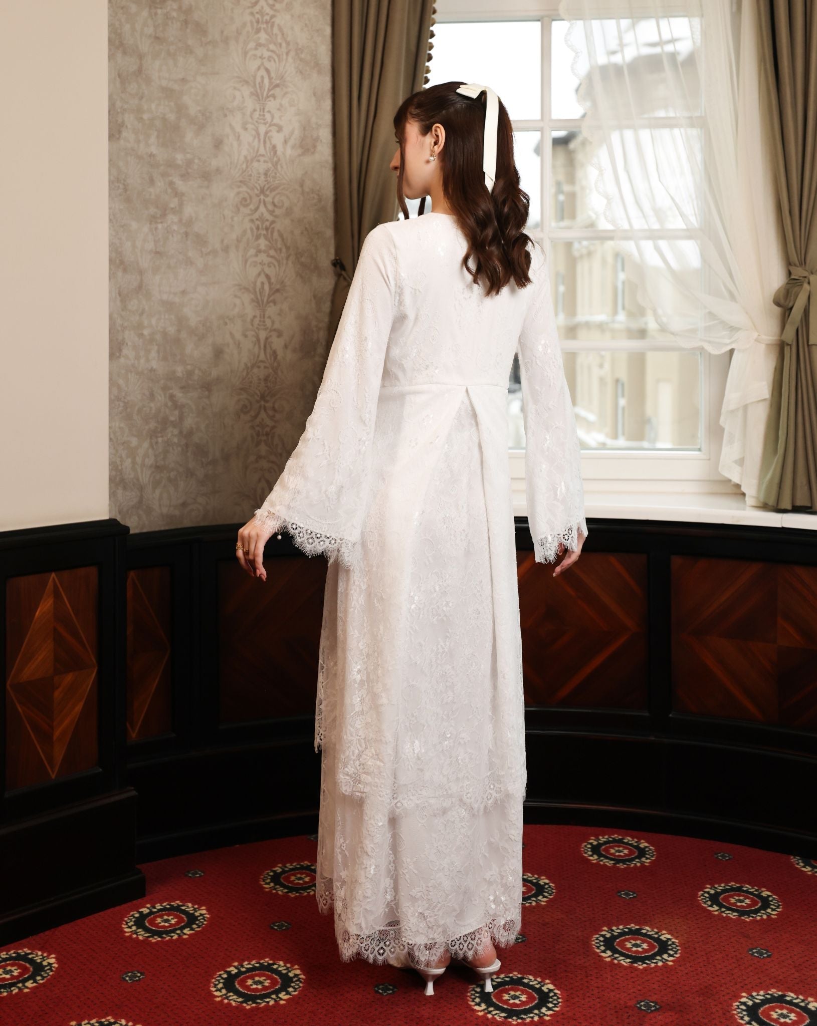 Rear view from the head down, showcasing the intricate lace that continues across the back for a romantic feel.