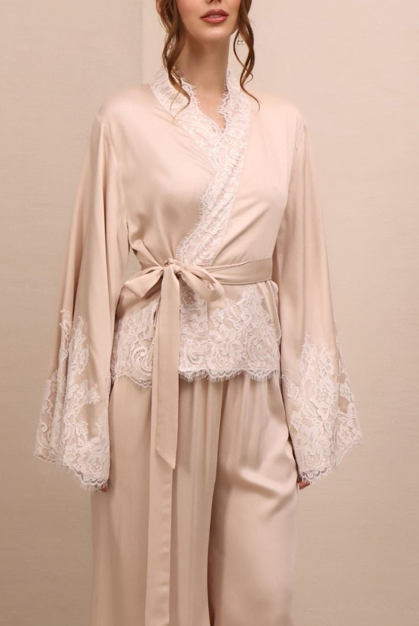 A mid-length shot of the Pyjamas Set, emphasizing the intricate lace-embellished wrap top and the elastic waistband.