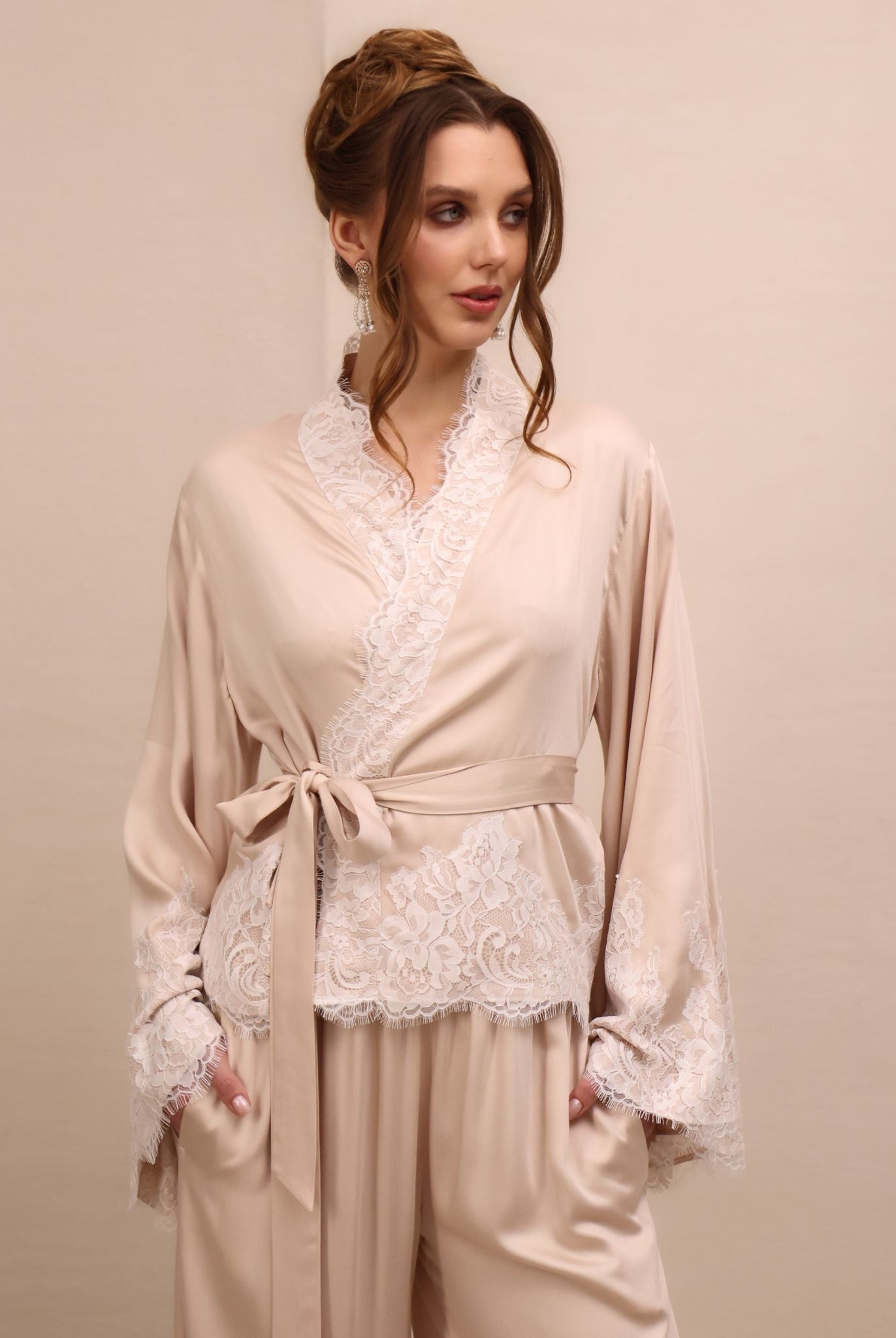 A close-up of the Pyjamas Set top, focusing on the wrap-over style and delicate lace detailing along the neckline.
