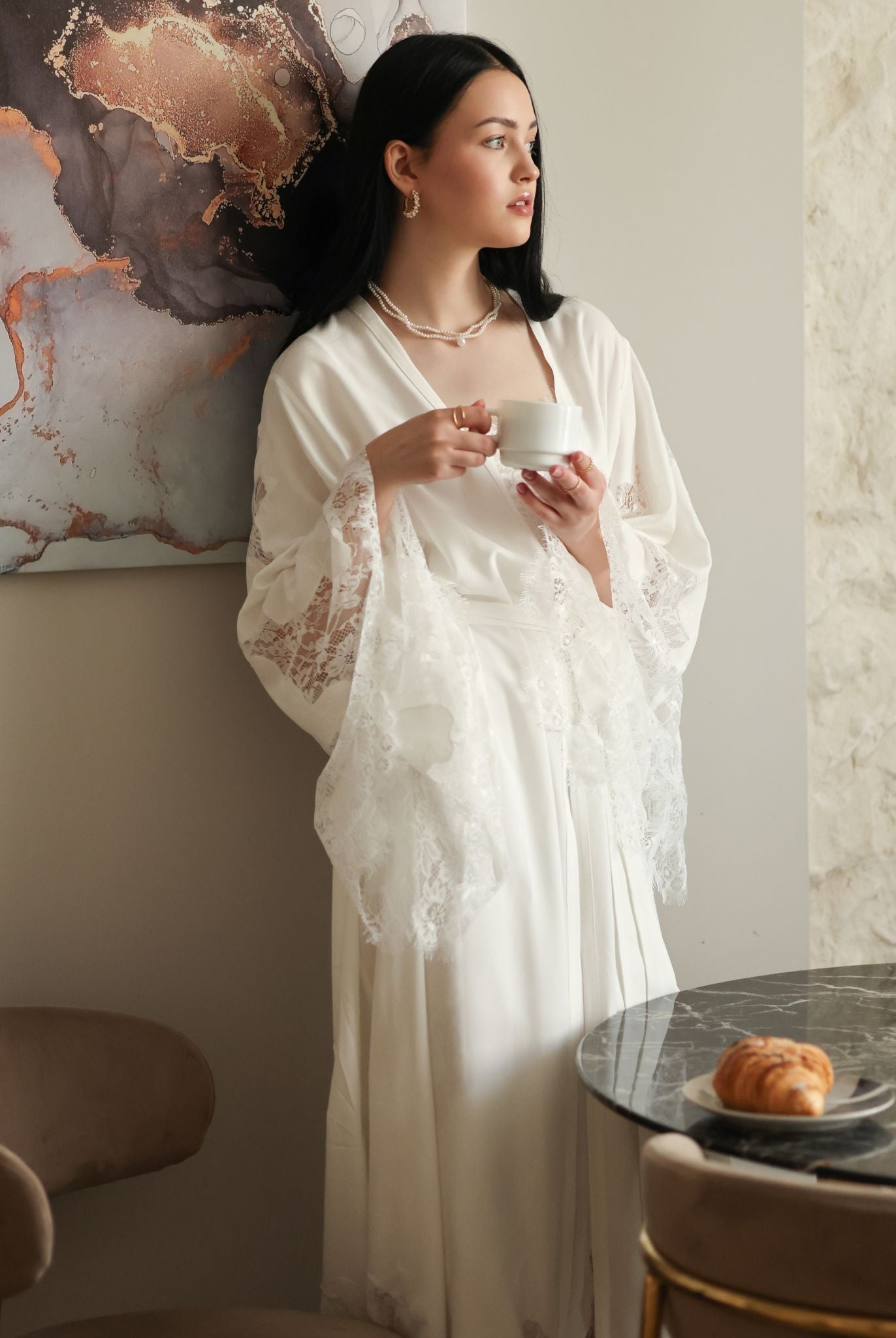 Relaxed scene in a cotton wrap holding a mug, capturing a moment of peace and modest elegance in loungewear.