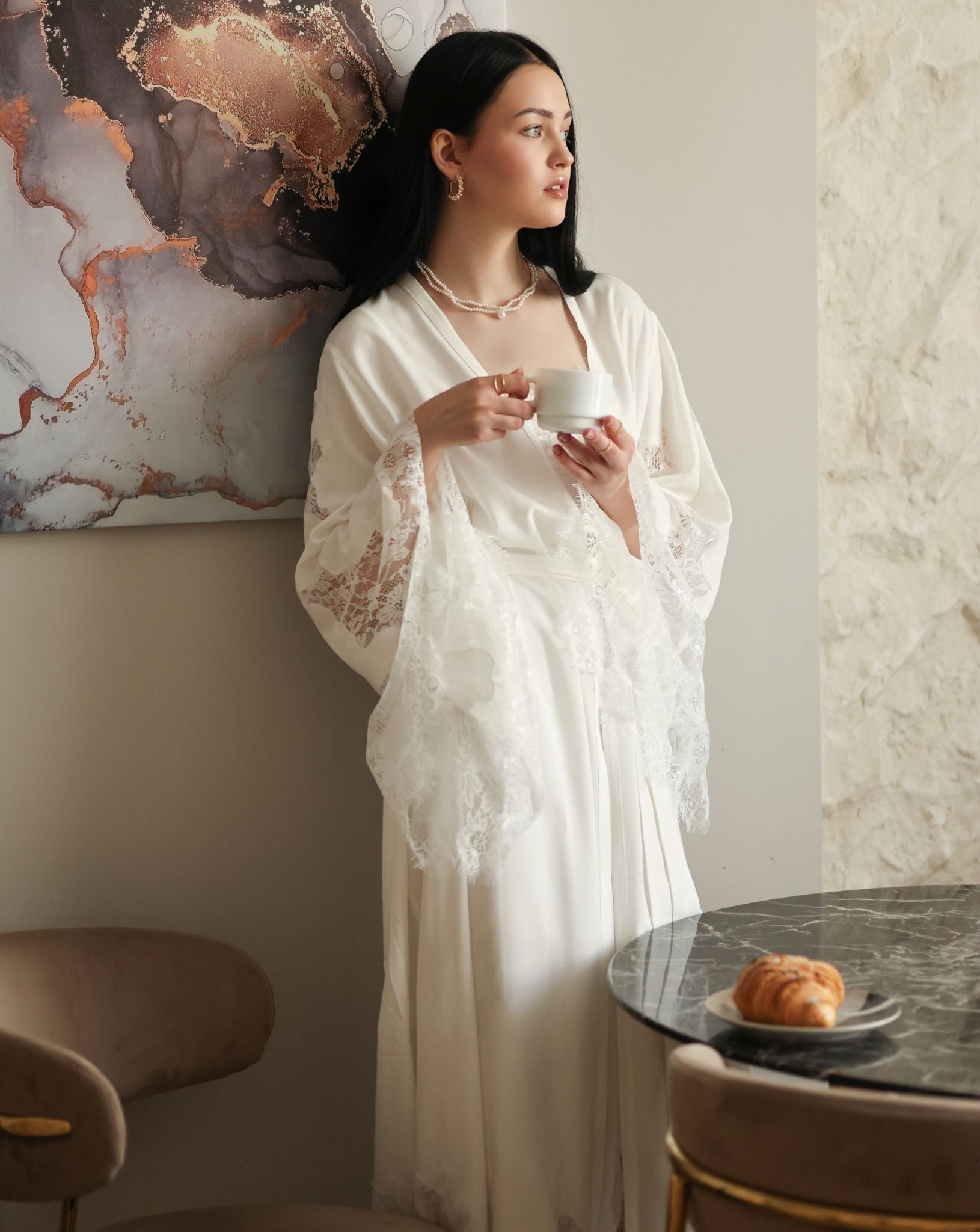 Relaxed scene in a cotton wrap holding a mug, capturing a moment of peace and modest elegance in loungewear.