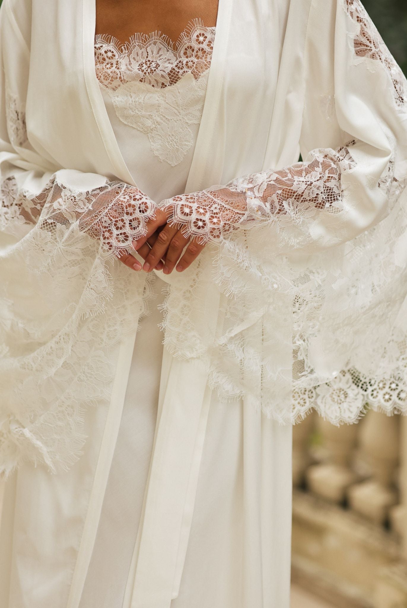 Close-up of the intricate lace detailing on the sleeves and neckline, showcasing the delicate and artistic charm.