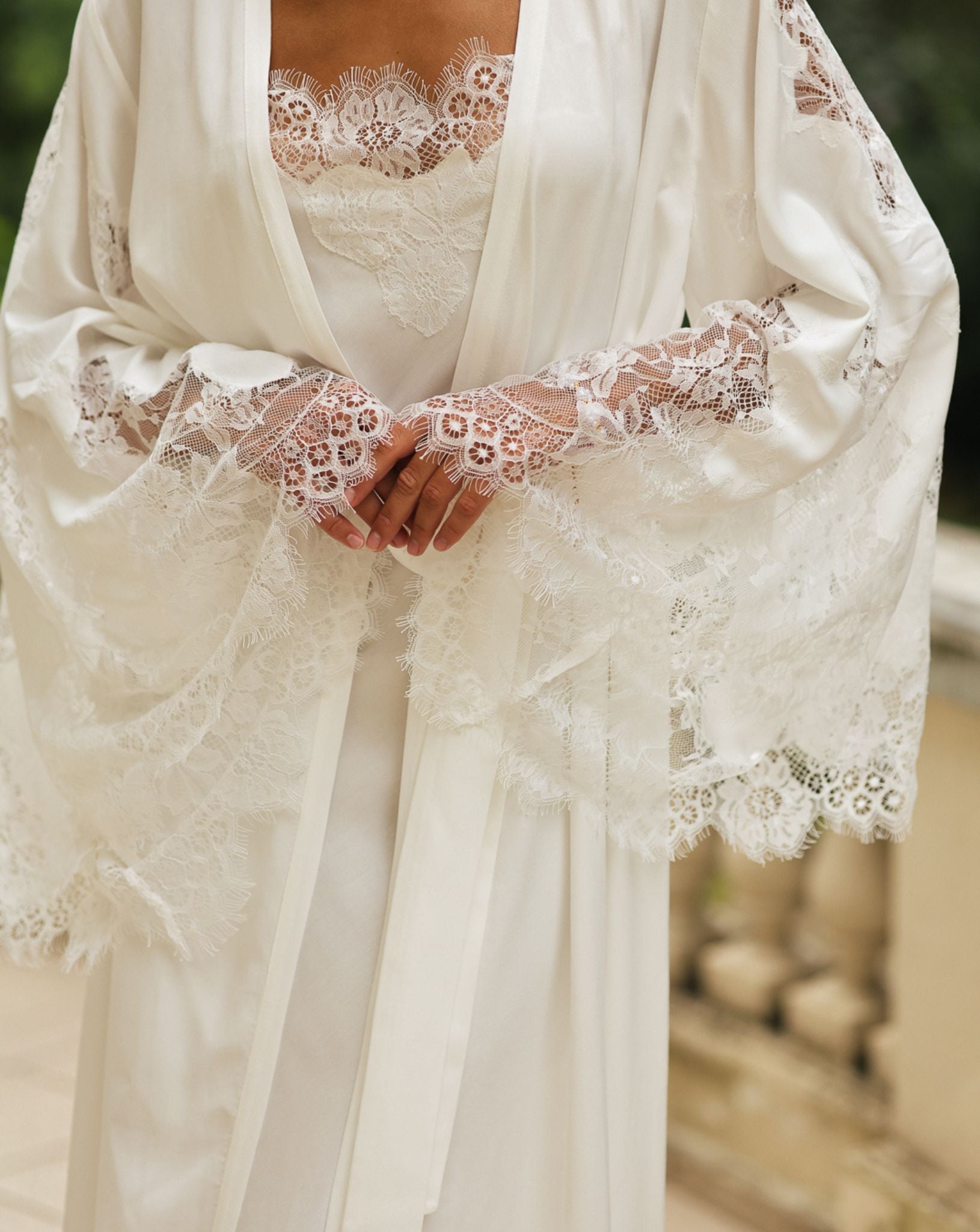 Close-up of the intricate lace detailing on the sleeves and neckline, showcasing the delicate and artistic charm.