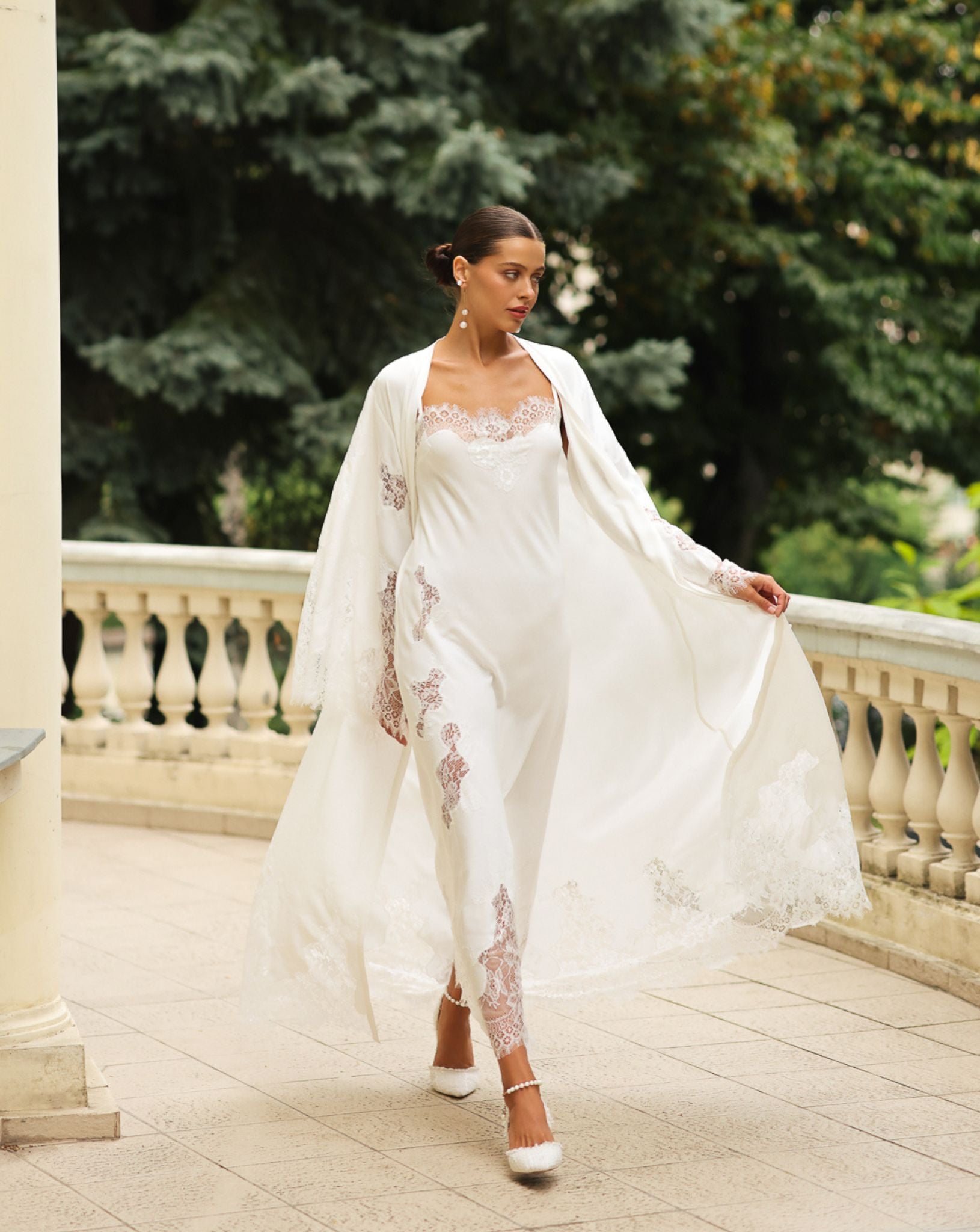 A flowing Robe and Nightgown Set in motion, showcasing the graceful drape and exquisite lace detailing of the cotton.
