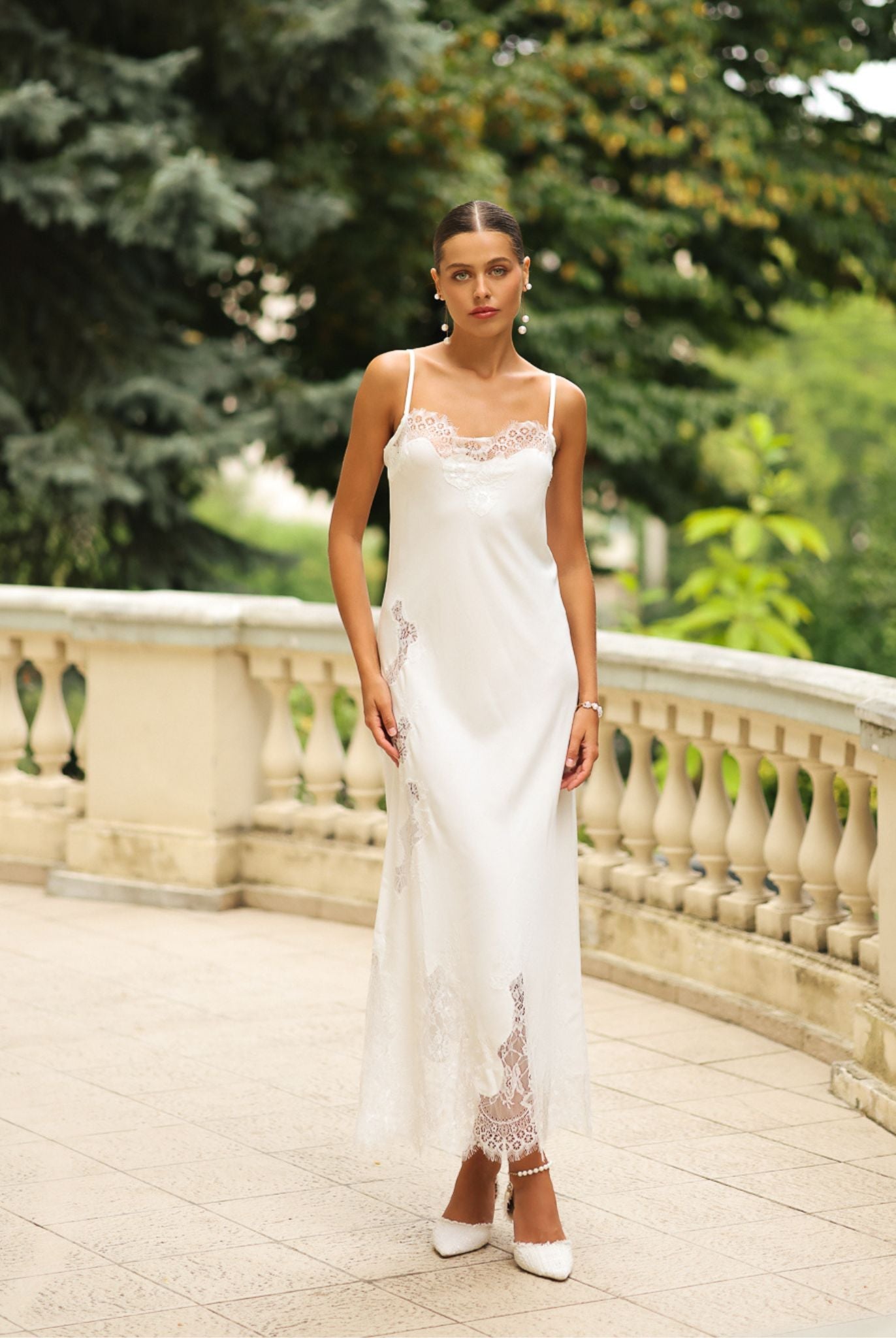 Frontal view of the long nightgown, featuring delicate lace embellishments and thin shoulder straps for a refined look.